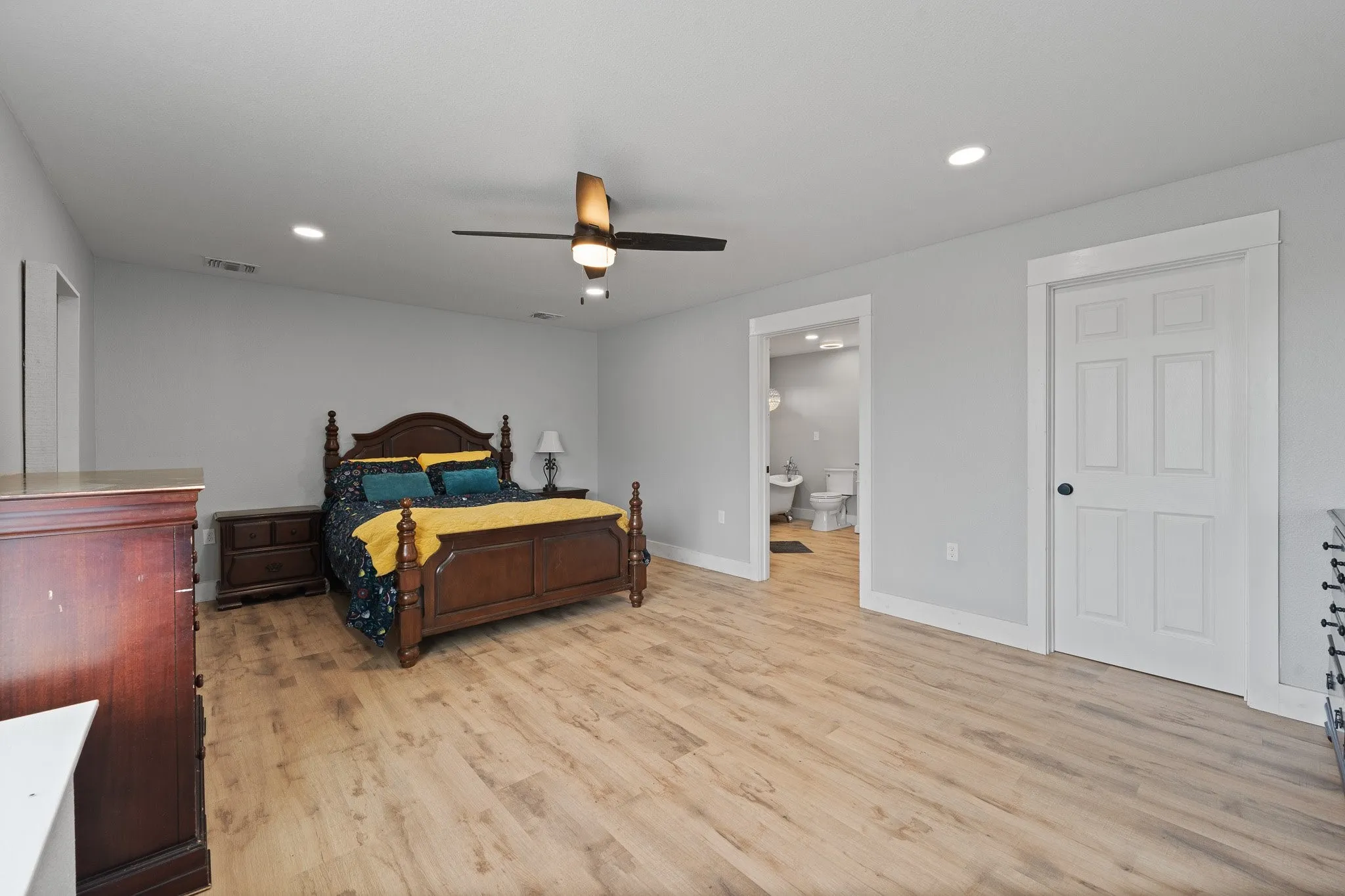 Primary Bedroom 2with light wood finished floors and ceiling fan