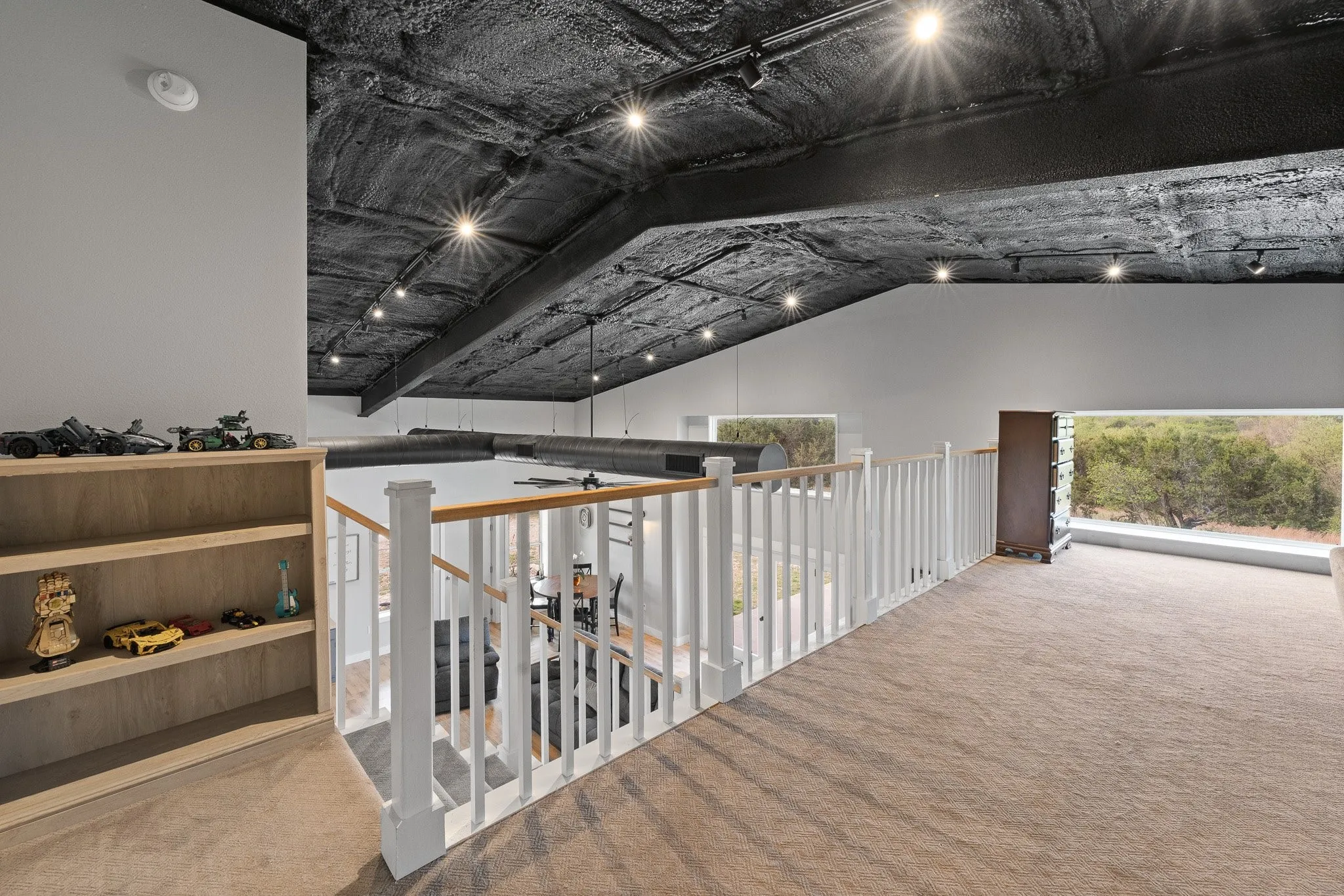 Loft with carpet flooring and rail lighting