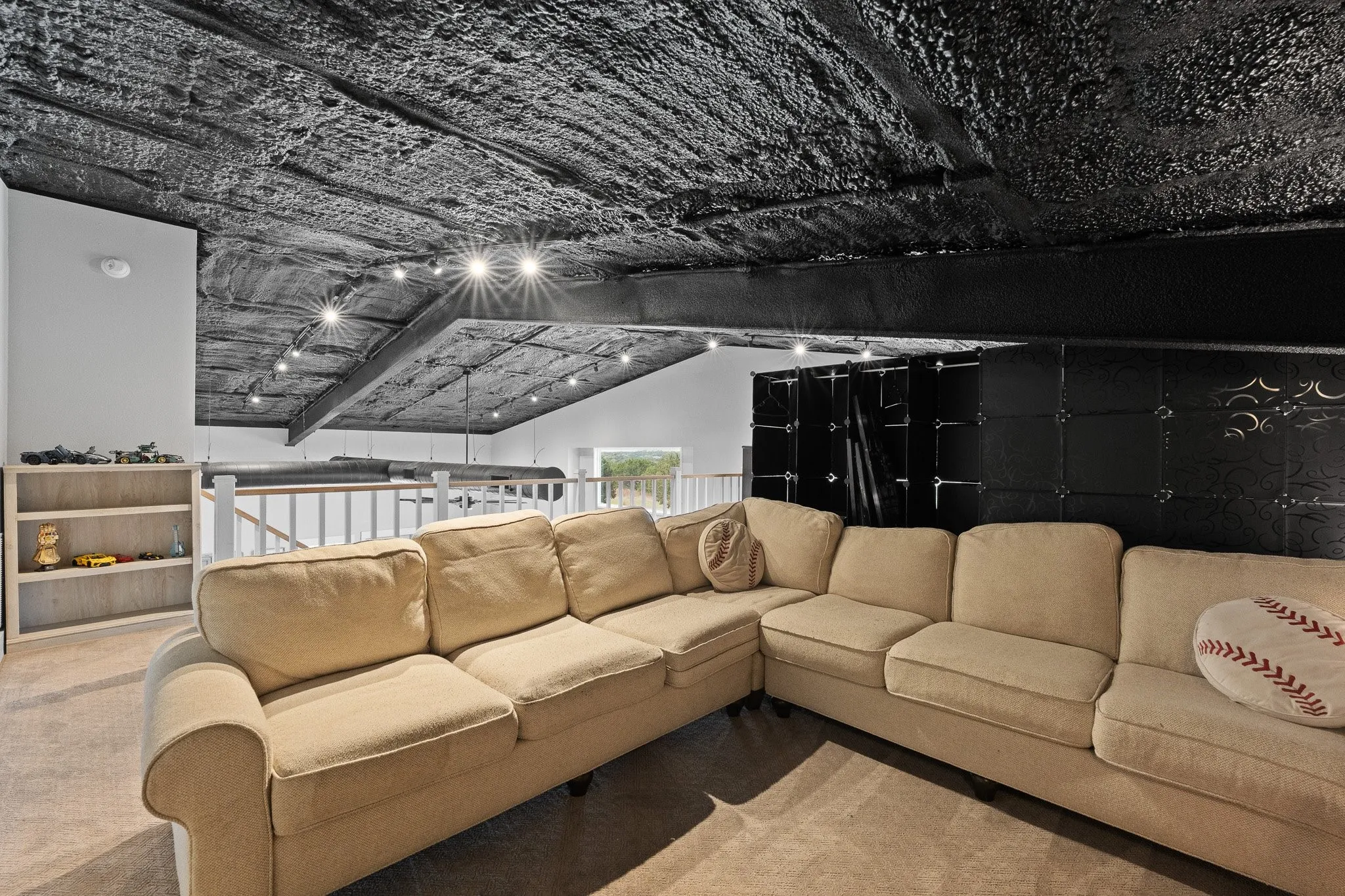 Loft Area with light colored carpet and lofted ceiling