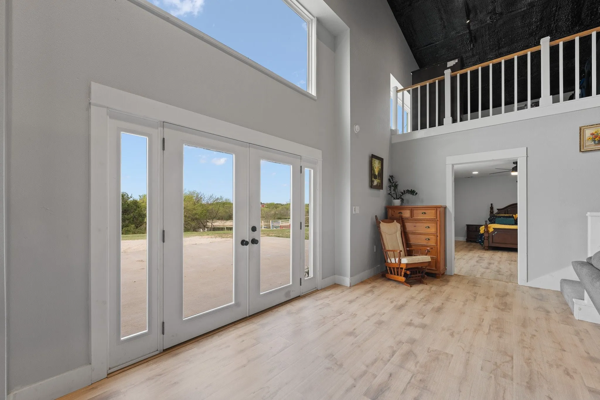 Entryway with wood finished floors, a high ceiling, french doors, and ceiling fan