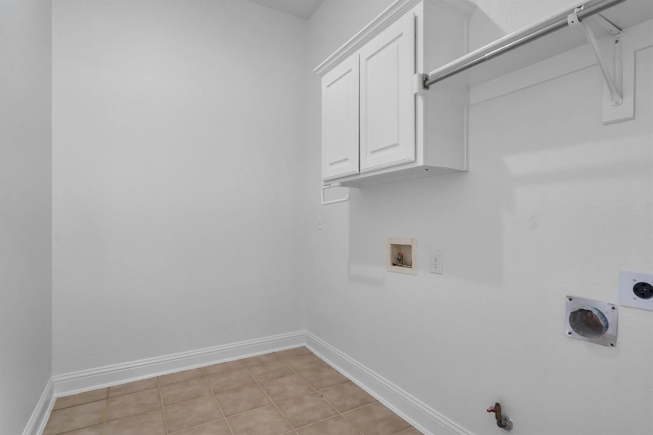 Oversized laundry room with plenty of room for a refrigerator and a folding station.  Dryer has electric or gas hookup.