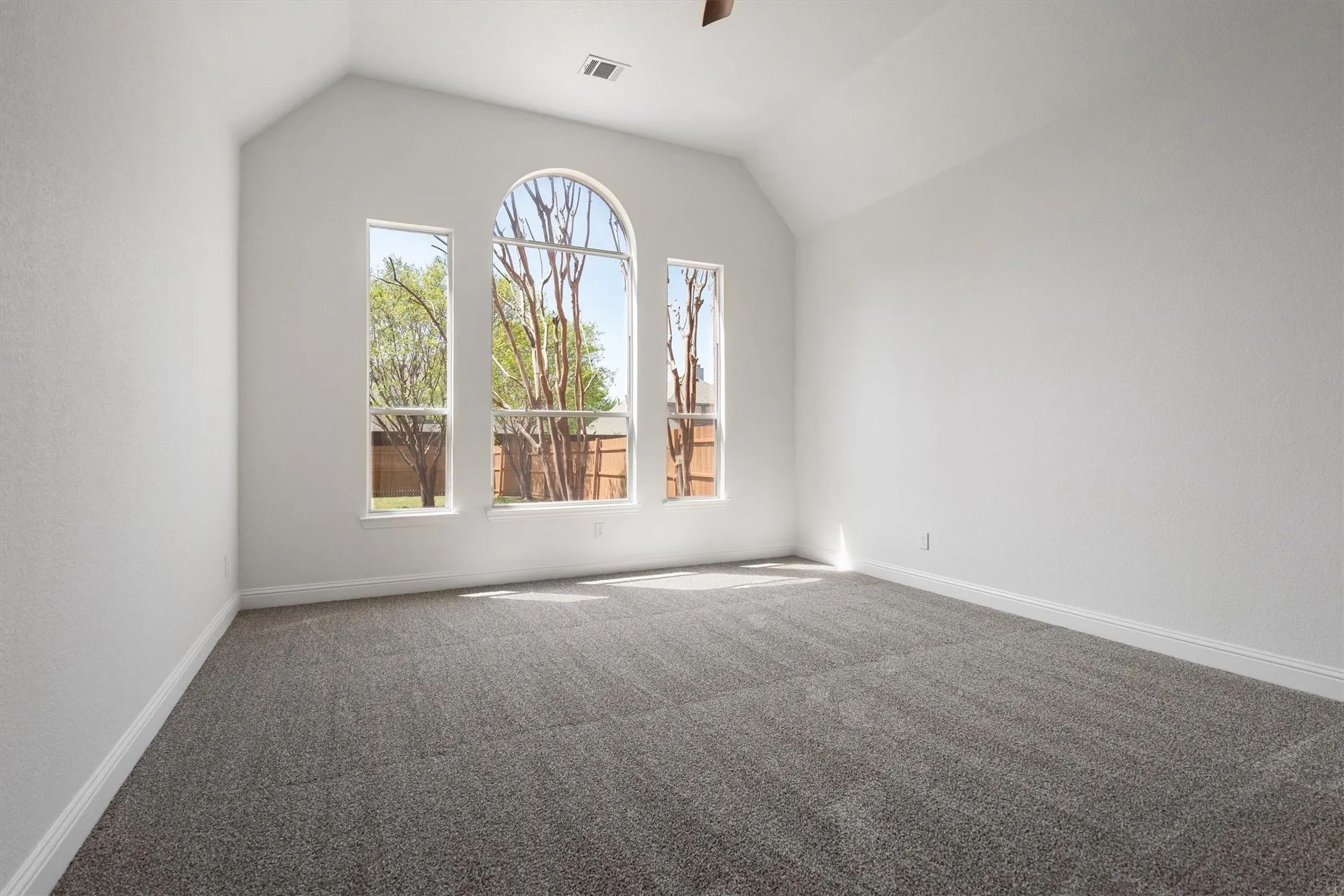 First floor primary suite with views of the backyard