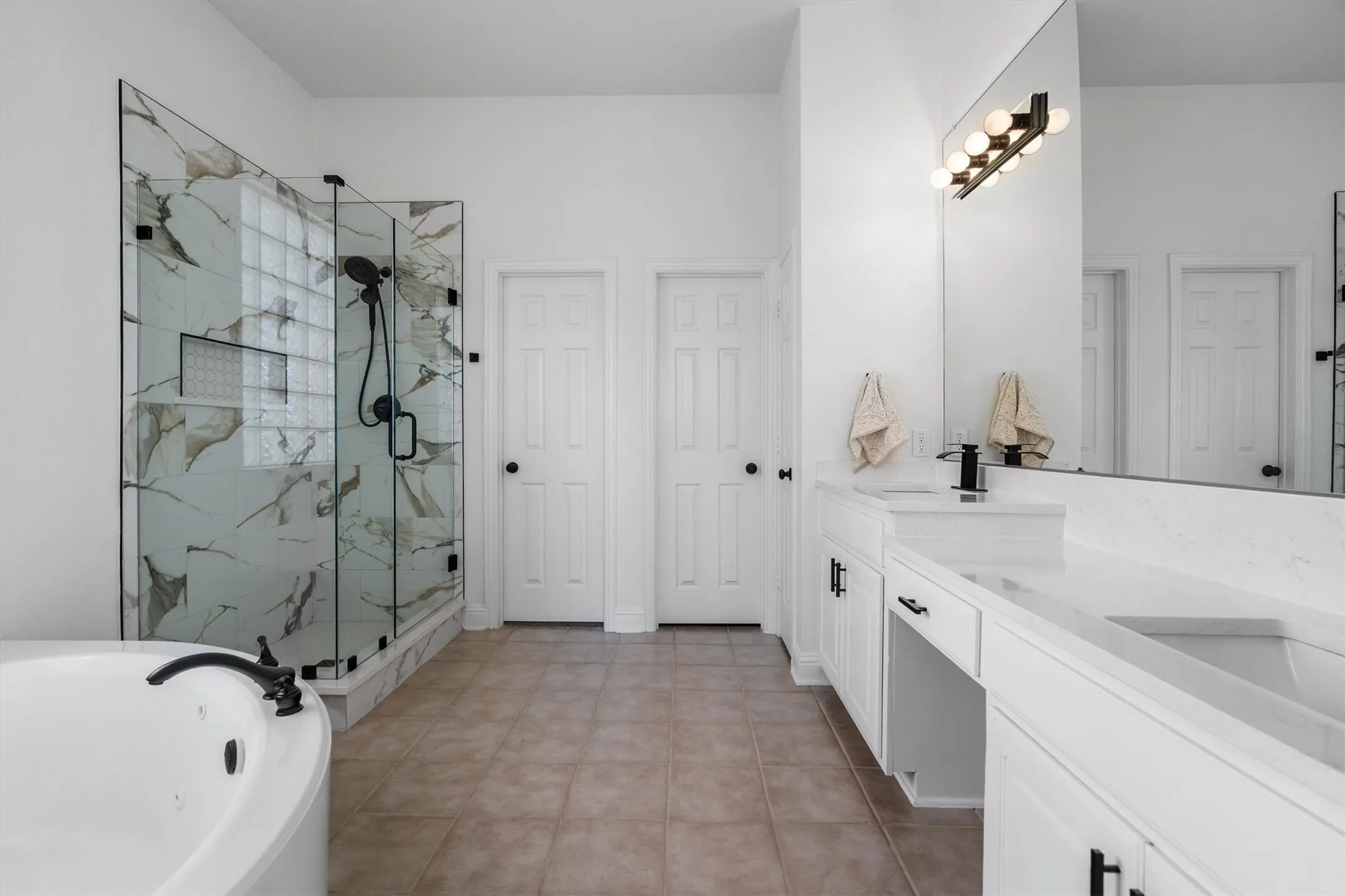 Primary bathroom with all new shower, countertops, faucets, and jetted tub for relaxation