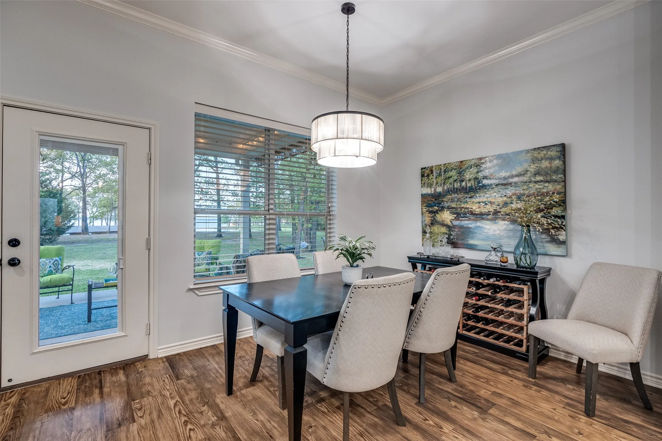 Dining room with wood finished floors and crown molding