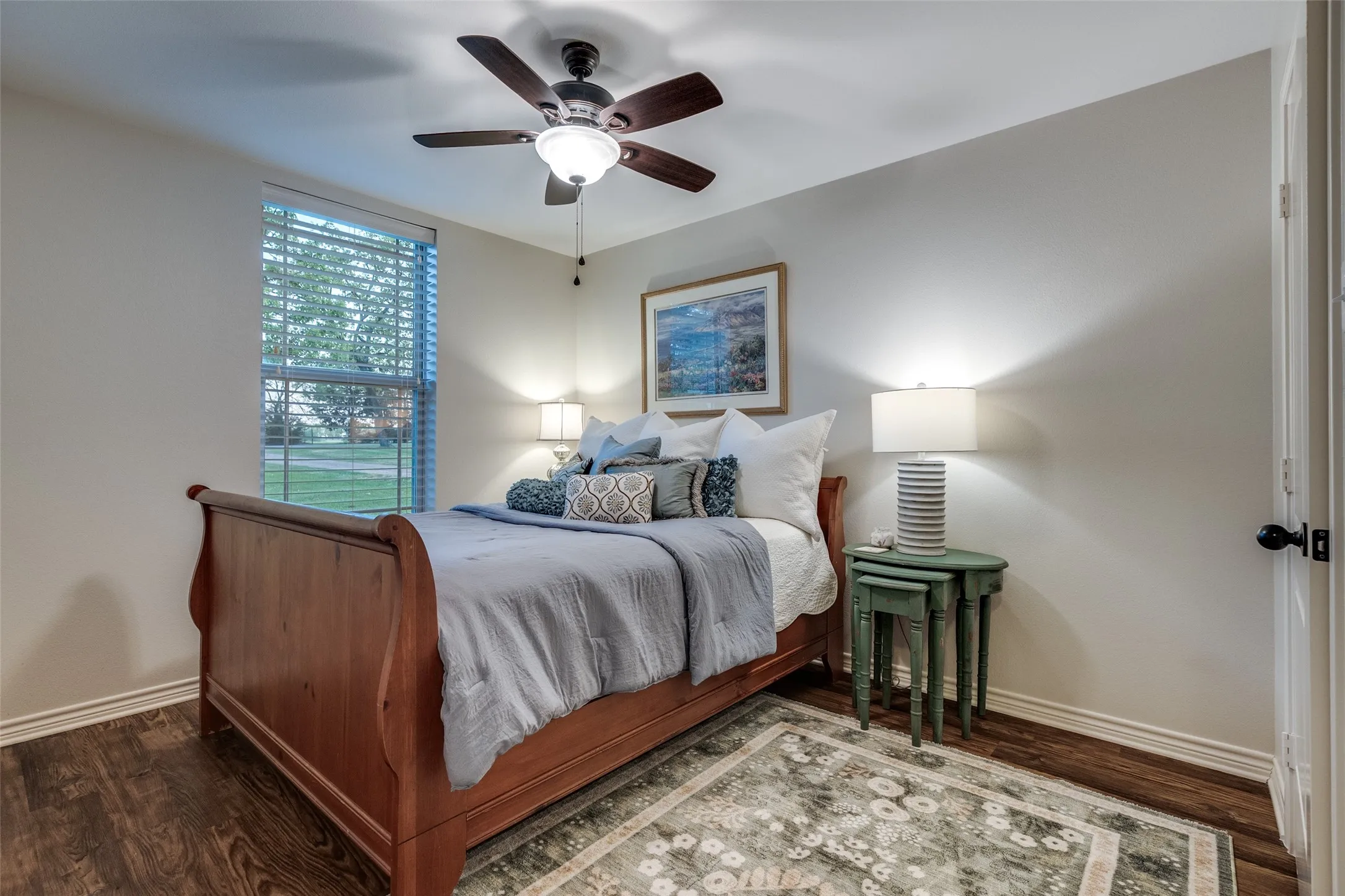Bedroom with dark wood-style floors and ceiling fan