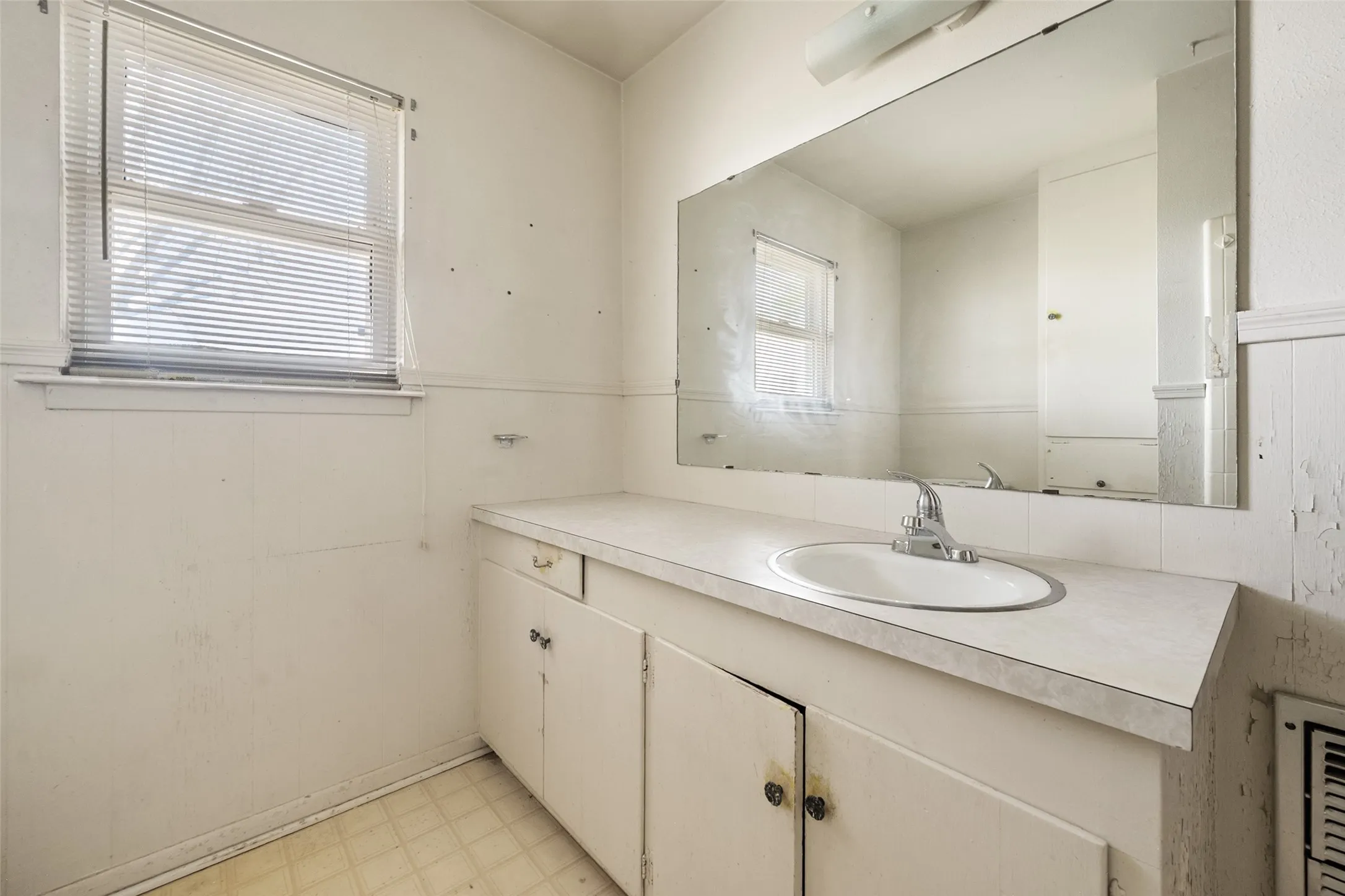 Bathroom featuring light flooring and vanity