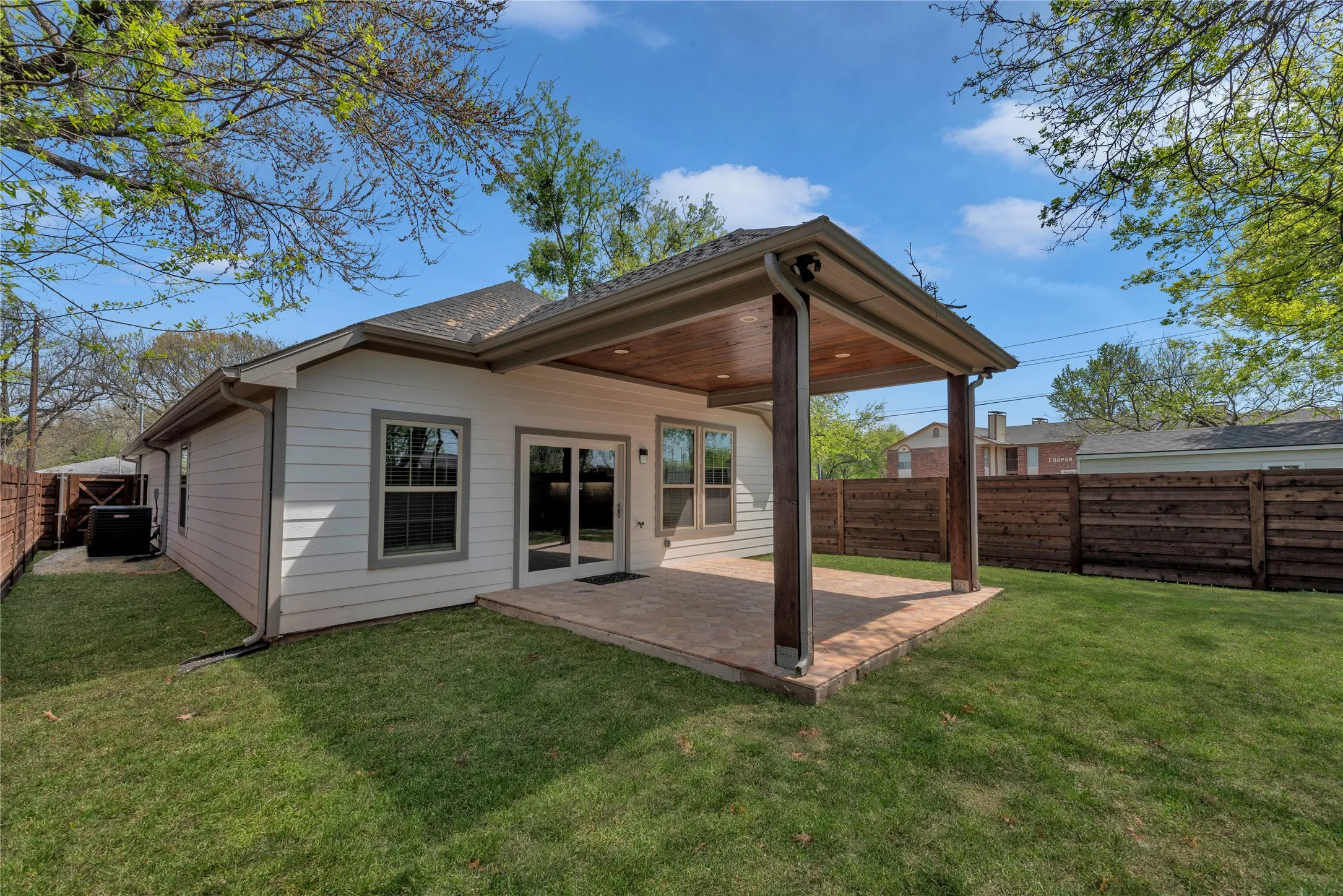 Backyard with privacy fence and covered patio
