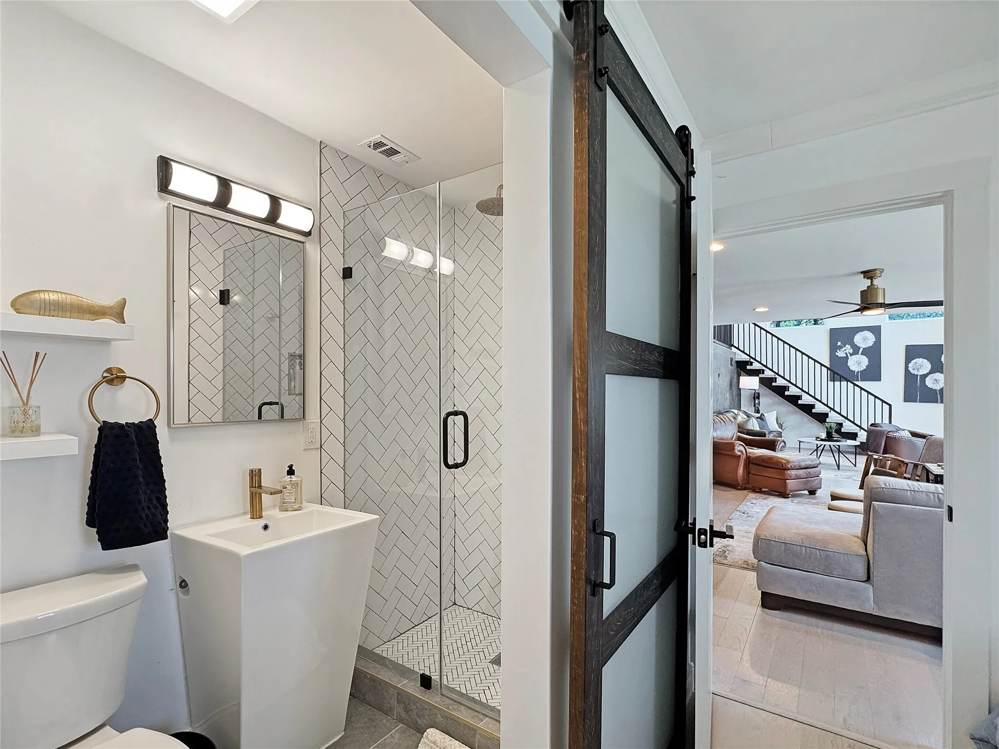 Full bath with a shower stall, a ceiling fan, and vanity on suite