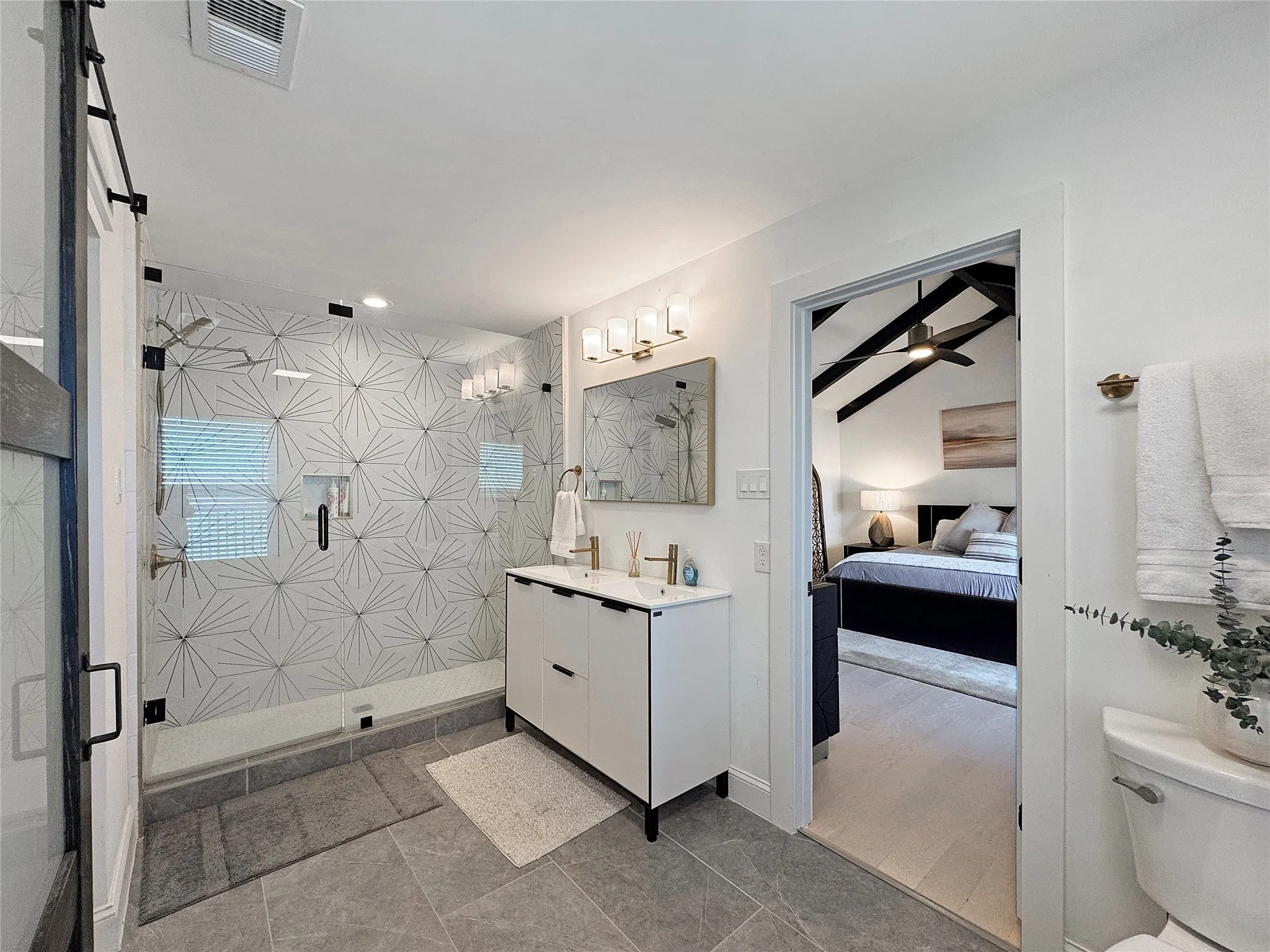 Full bathroom featuring a shower stall, vanity, and ensuite bath