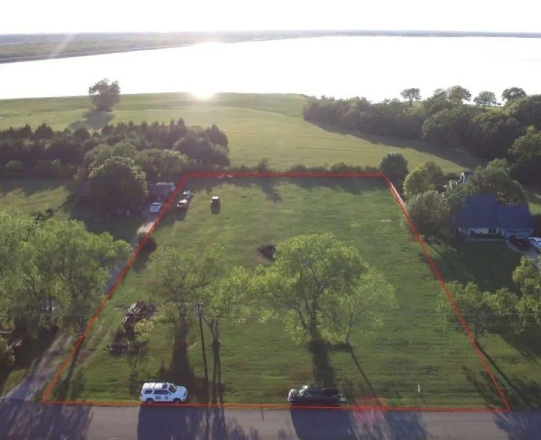 View is with residential development behind the drone. Lot 4 is on the right side of this photo. Lot 5 is to the left and has been SOLD.