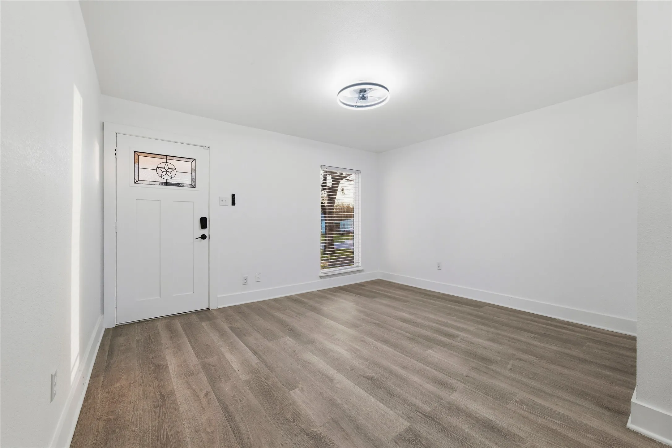 Foyer entrance featuring baseboards and wood finished floors