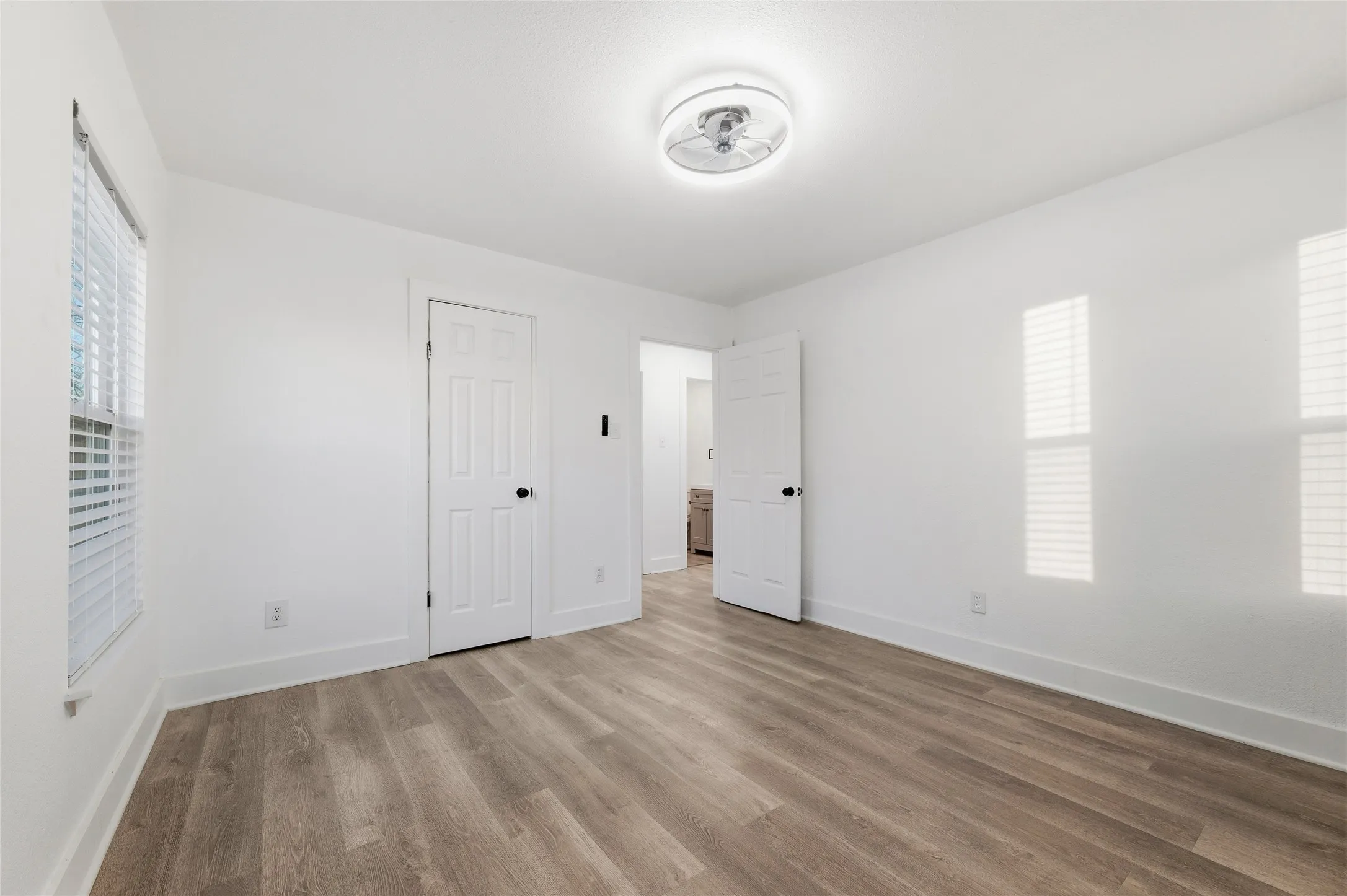 Unfurnished bedroom featuring baseboards and light wood-type flooring