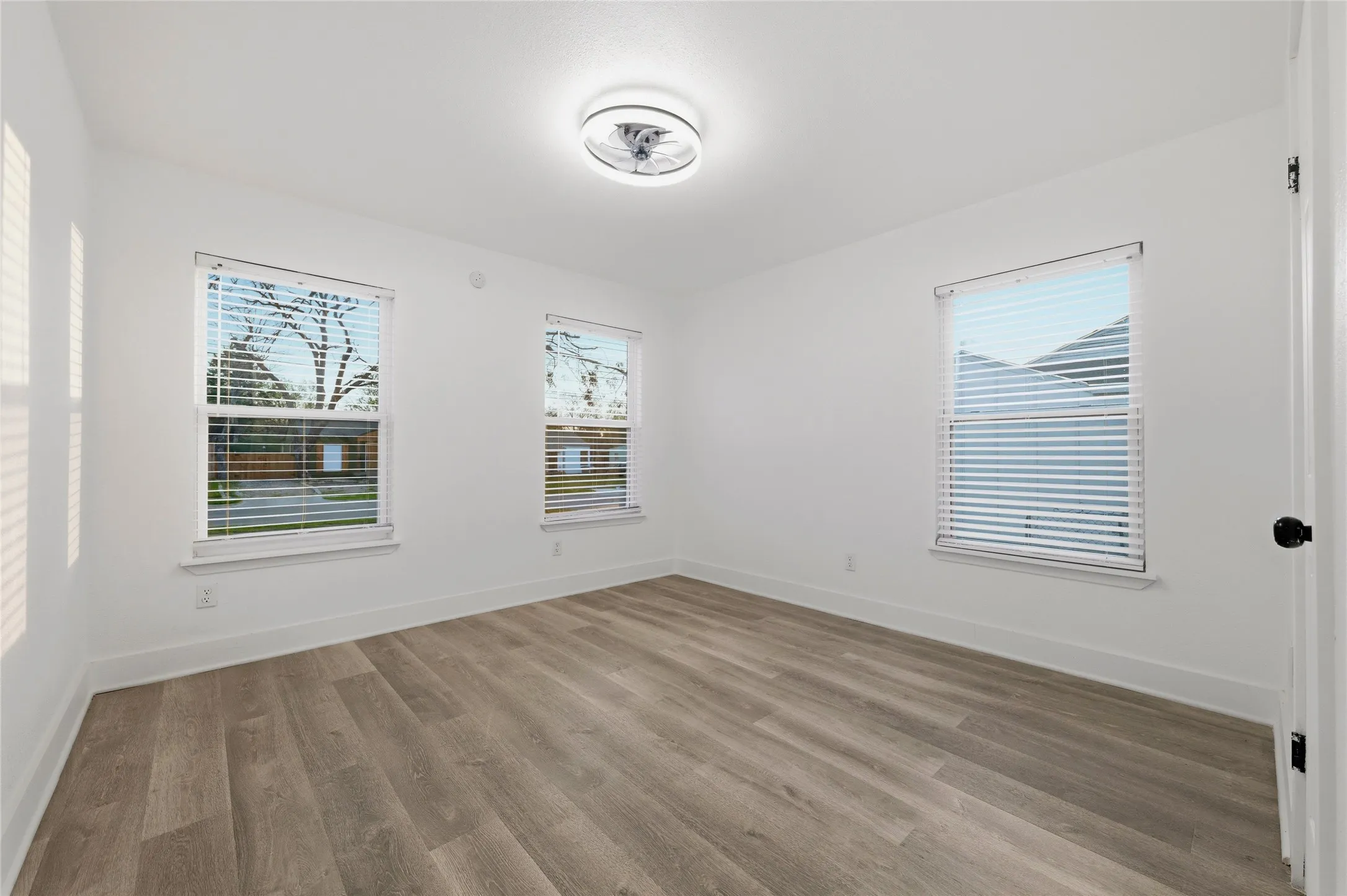 Spare room with light wood-style floors and plenty of natural light