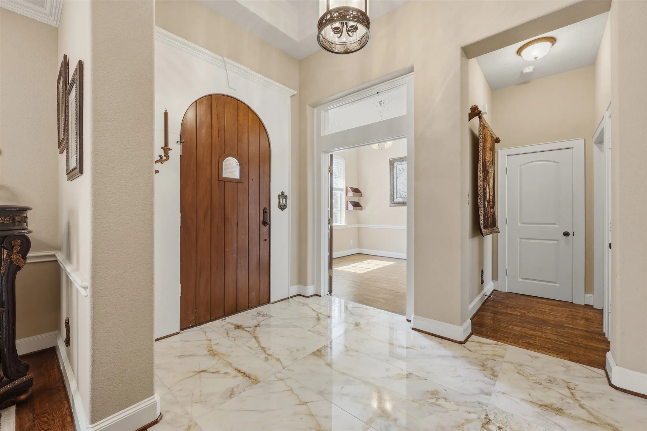Marble entry flooring, office off the front of the home through french doors