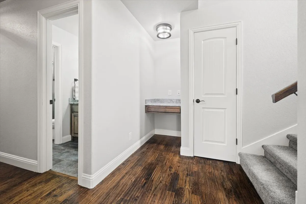 Hall featuring dark wood-type flooring