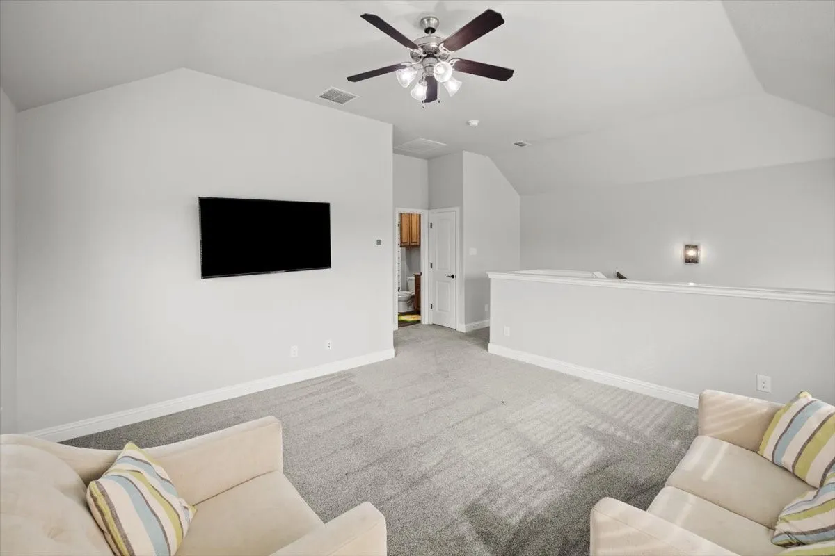 Living room with carpet floors and a ceiling fan