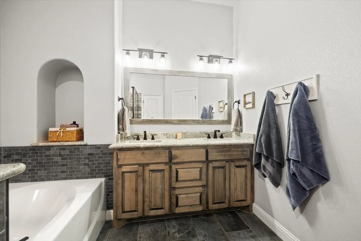 Bathroom with double vanity and a bath