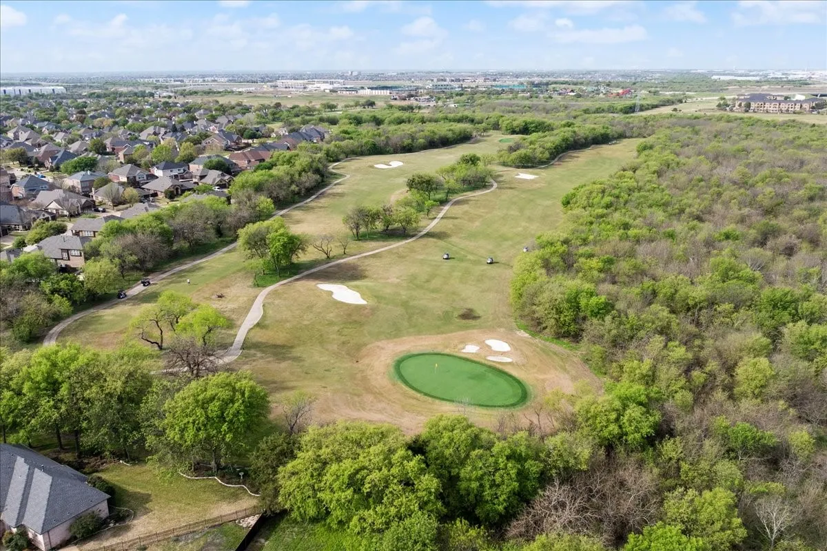 Aerial perspective of suburban area featuring a golf club