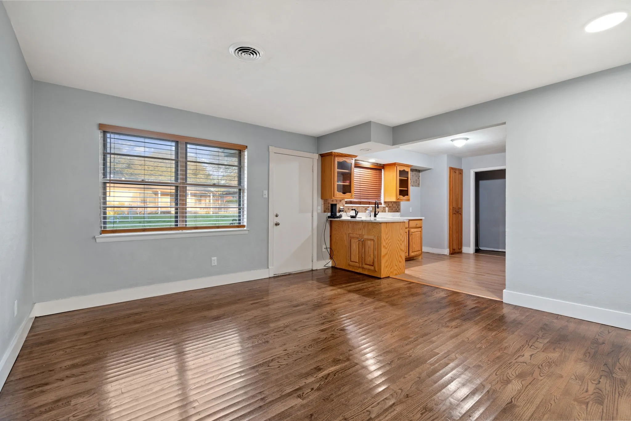 Unfurnished living room with dark wood finished floors and baseboards