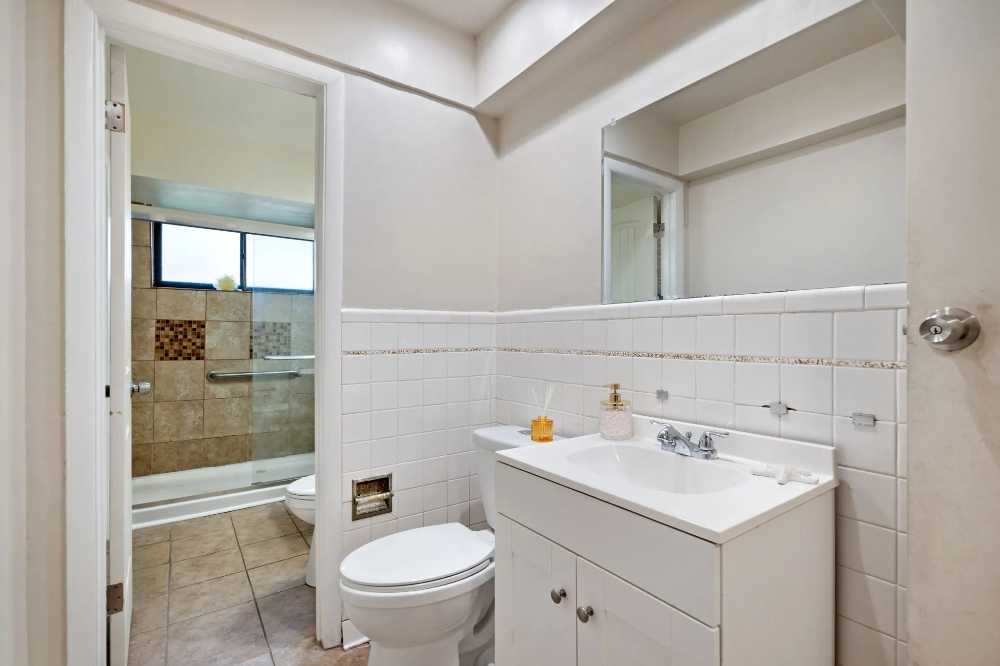 Kitchen with glass insert cabinets, light countertops, a peninsula, light wood-style flooring, and decorative backsplash