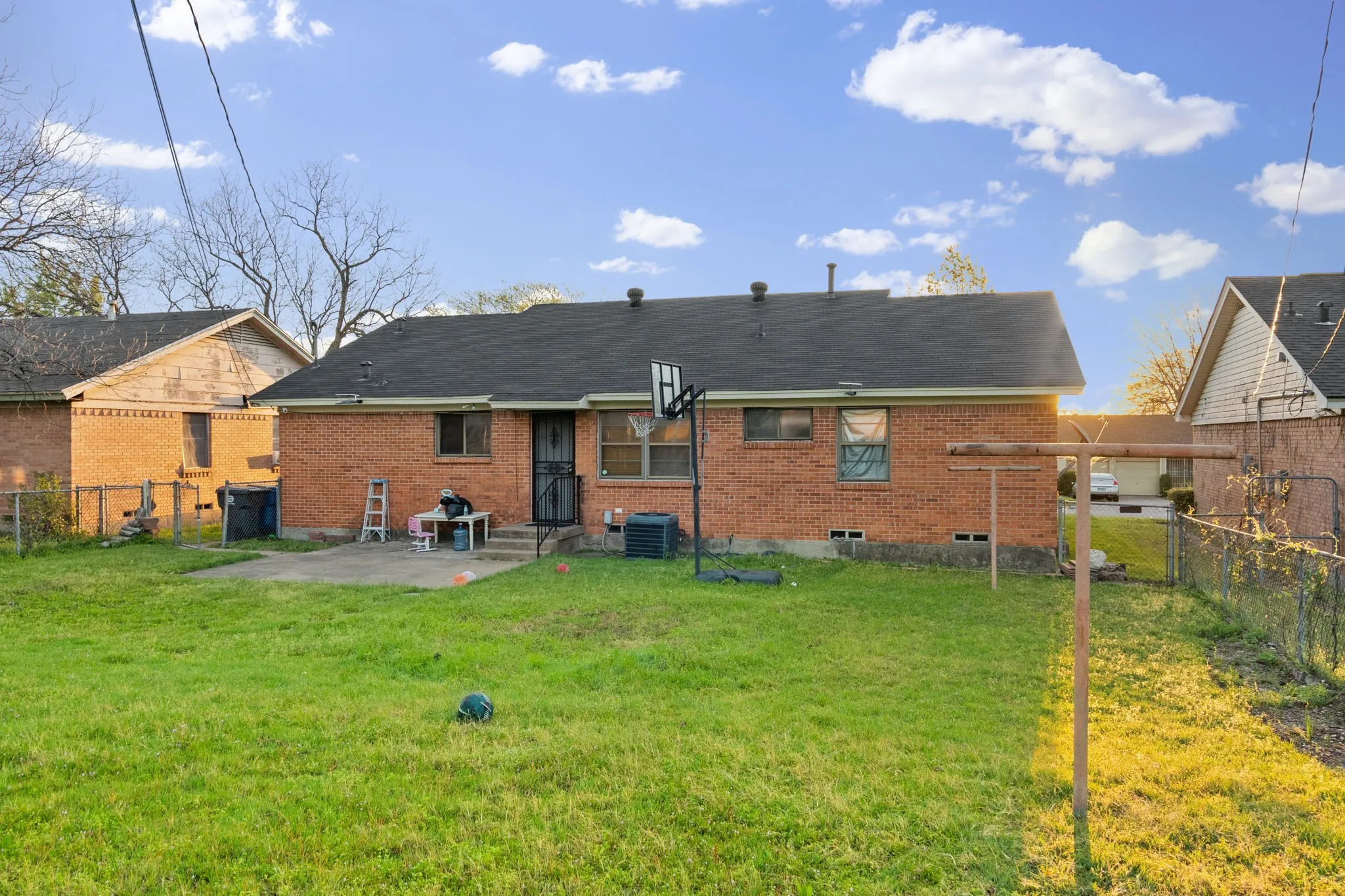 Rear view of house featuring a patio and brick siding