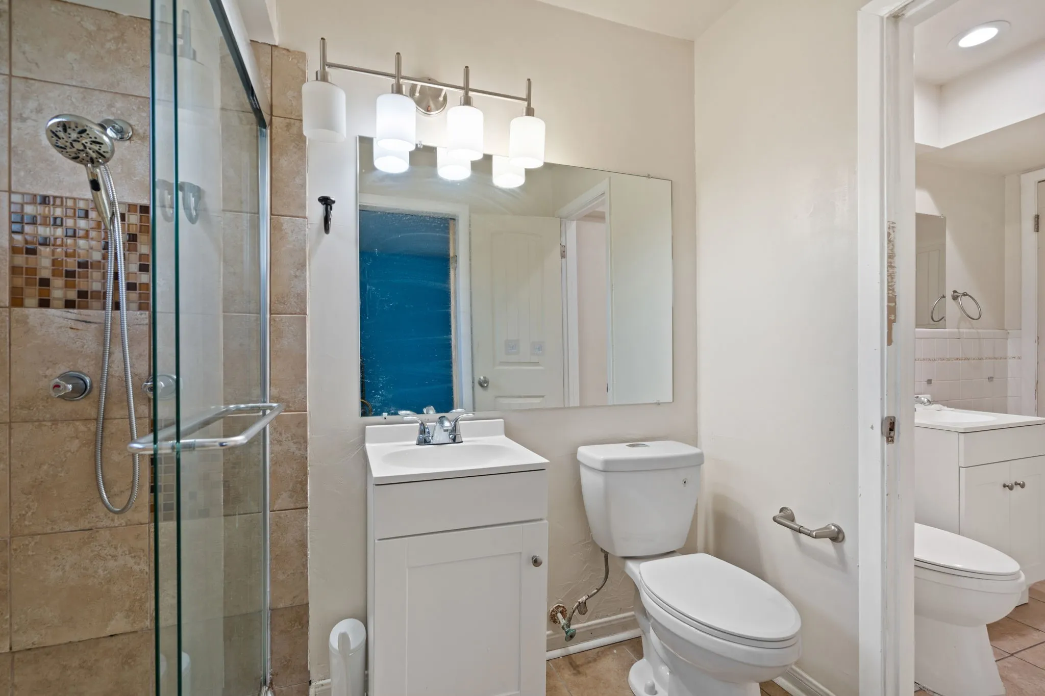 Full bath with vanity and a shower stall