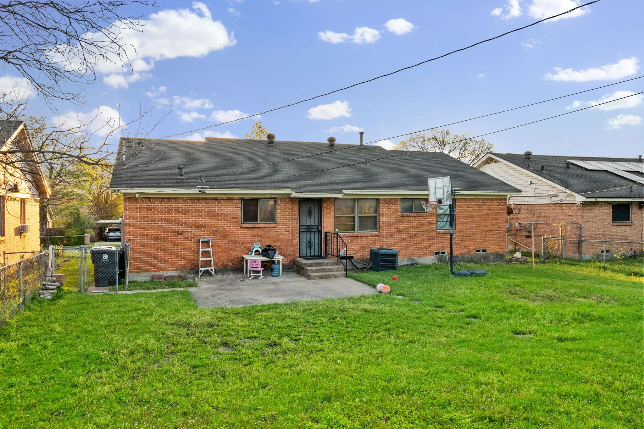 Rear view of property featuring a patio area, brick siding, a gate, and entry steps