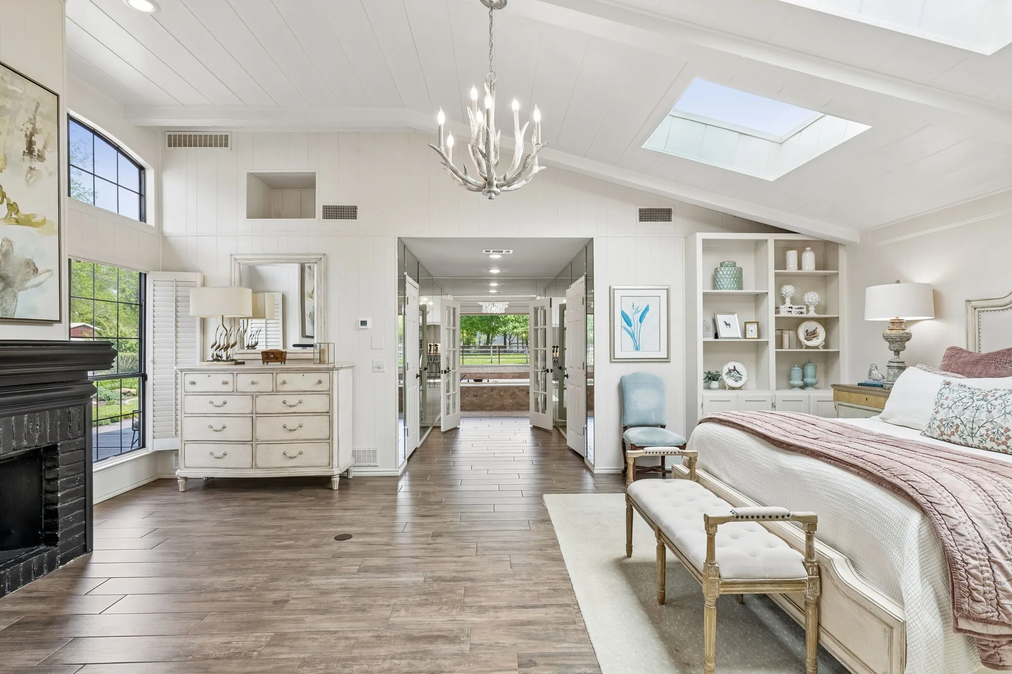 Renovated master suite flooded with natural light and custom lighting.  Pictures don't do this space justice