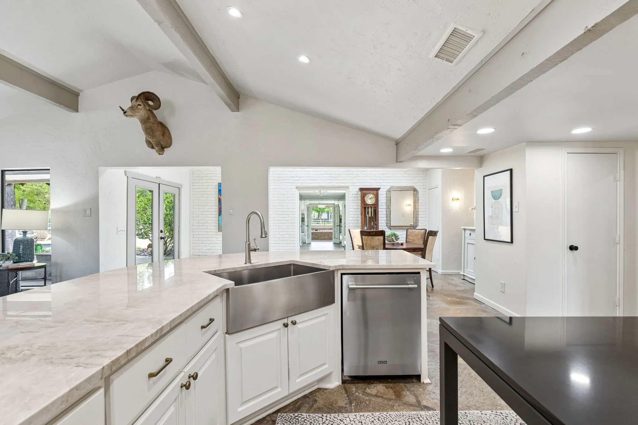 Stainless appliance and farm house sink with multiple dining areas