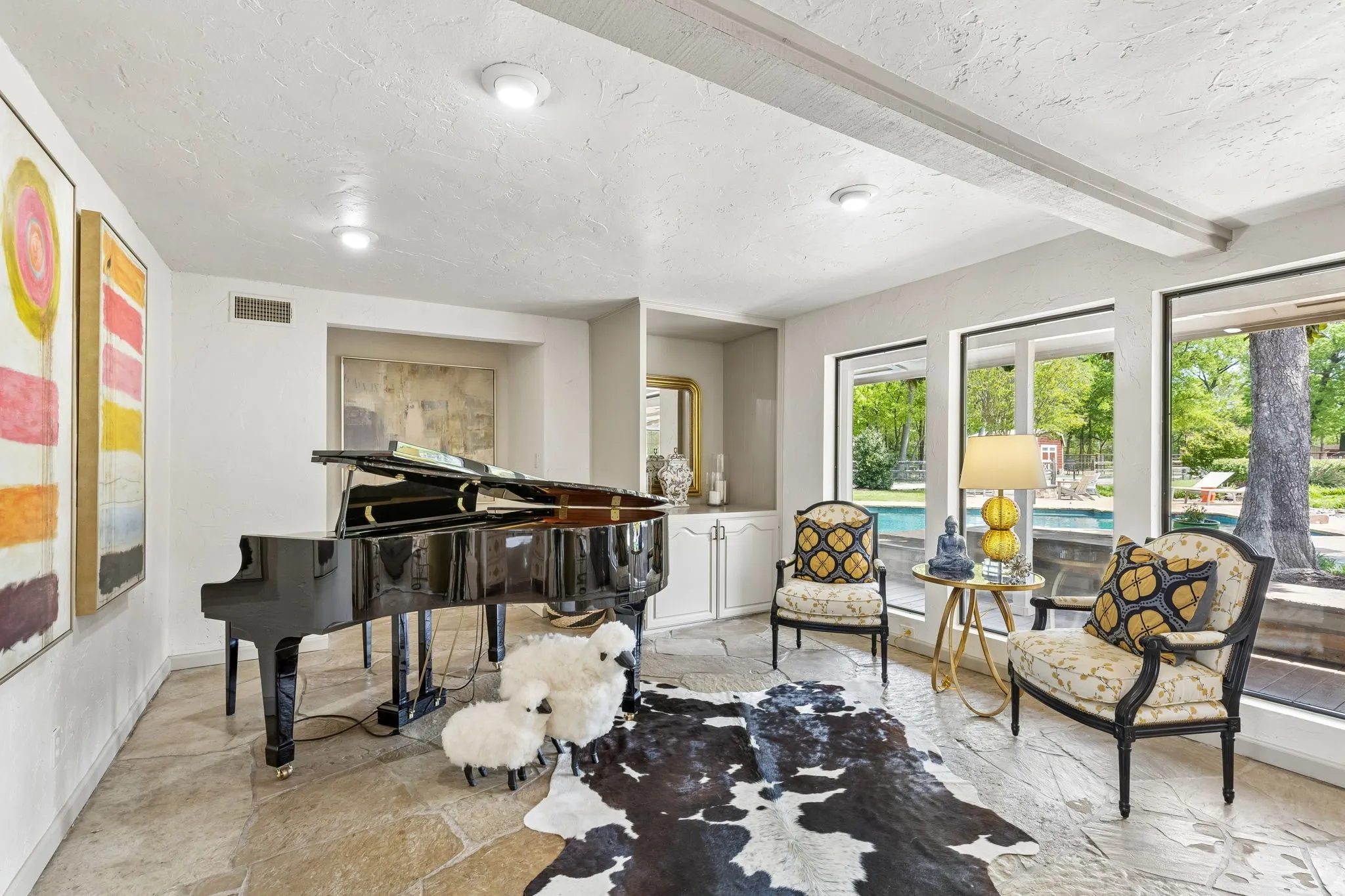 Additional living space perfect for your piano  with a recessed dry bar.