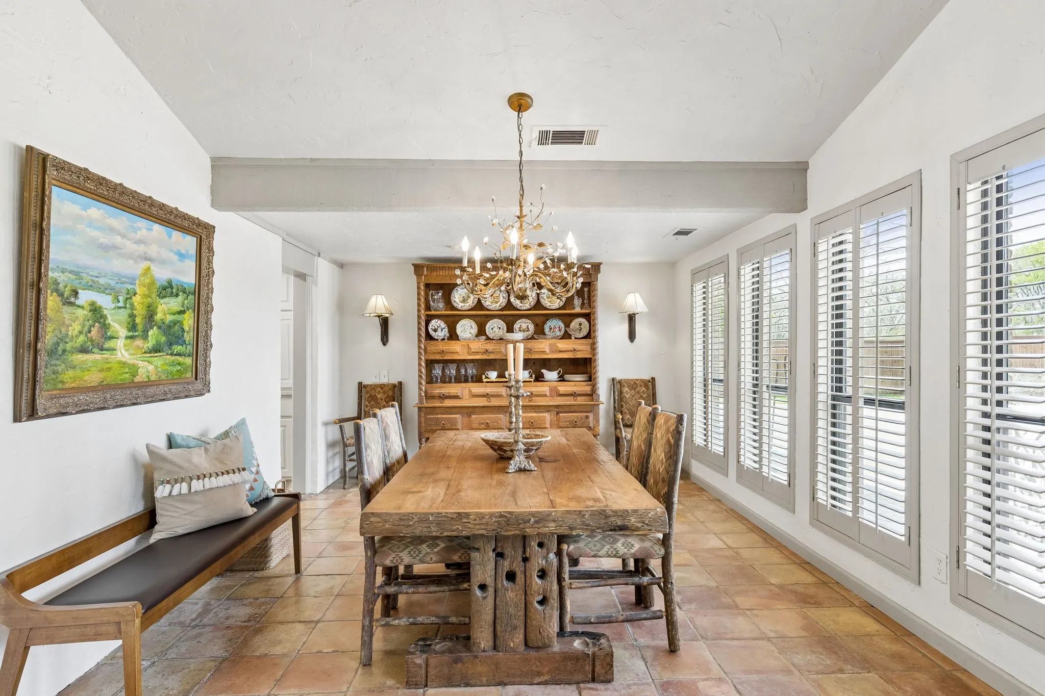 Oversized dining room with custom lighting.  Sellers willing to sell both table and hutch to new buyers as it fits perfectly with the style and decor of the home.