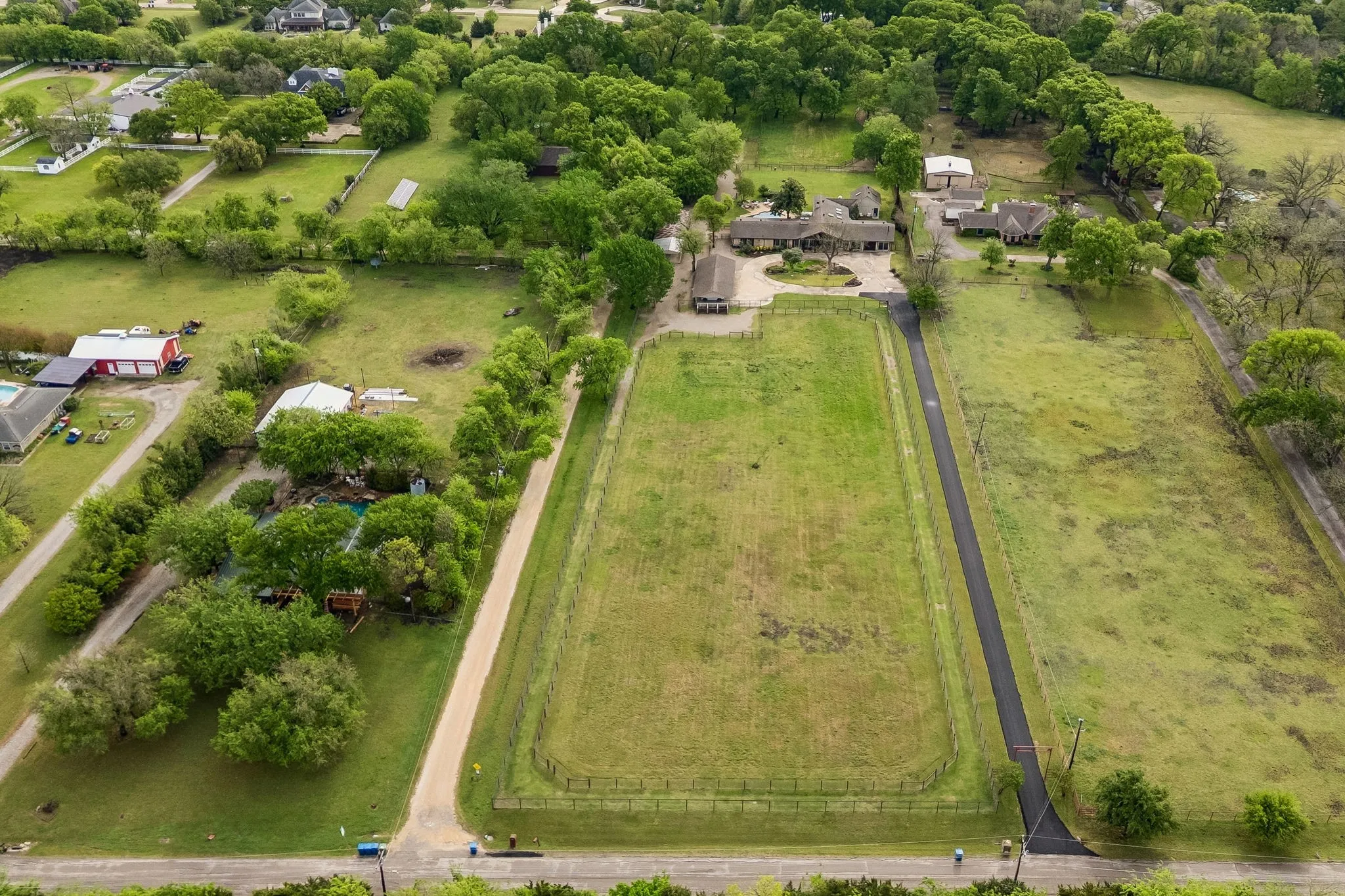 Long extensive paved driveway leads to a stunning circular driveway with parking for 10 or more cars.