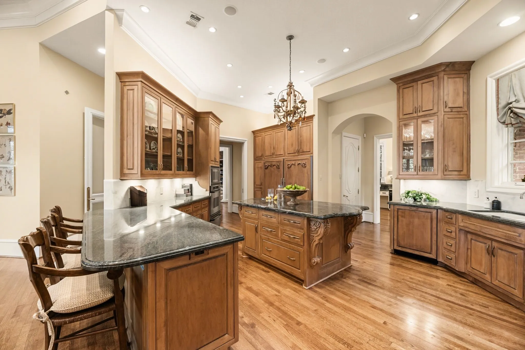 Kitchen has breakfast bar and overlooks family room
