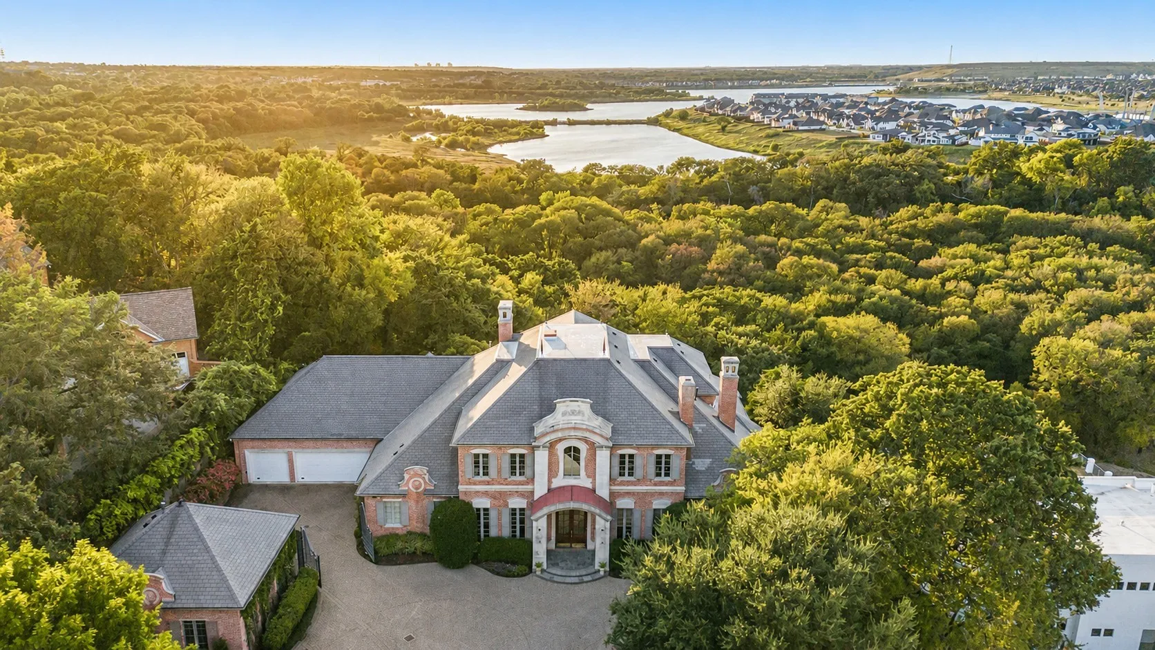 Home sits on 2 acres backing to the West Fork Branch of Trinity River and overlooks Lake Viridian