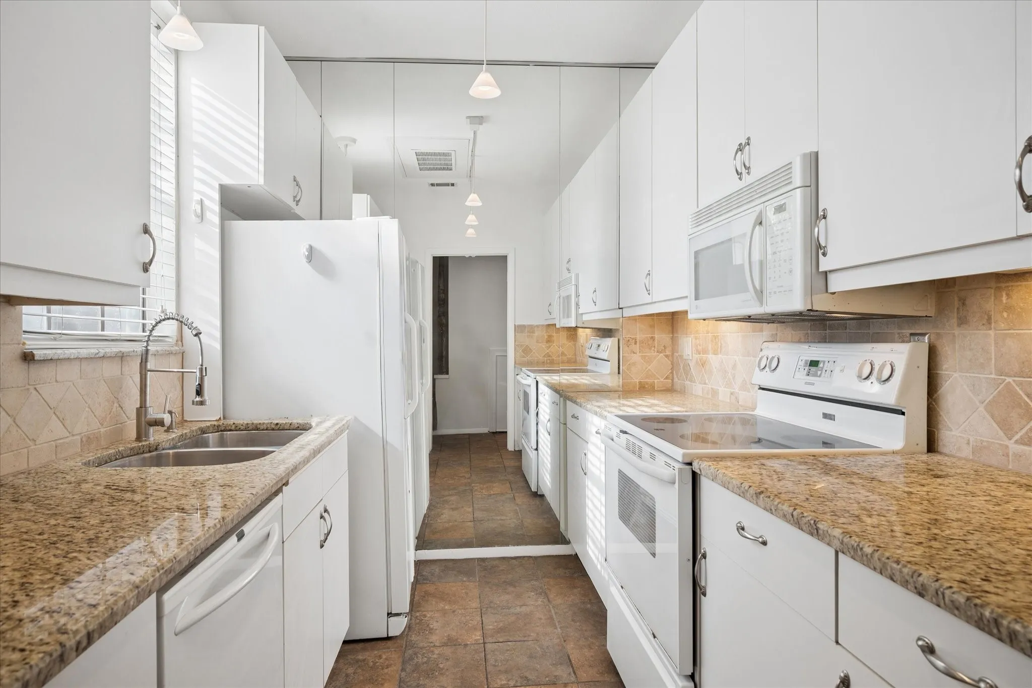 Galley Kitchen Has Plenty Of Cabinet And Counter Space