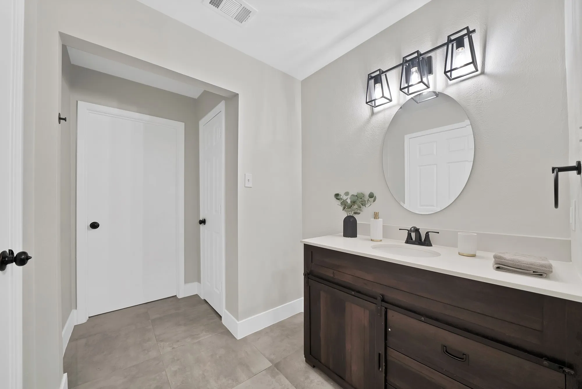 Bathroom featuring vanity and baseboards