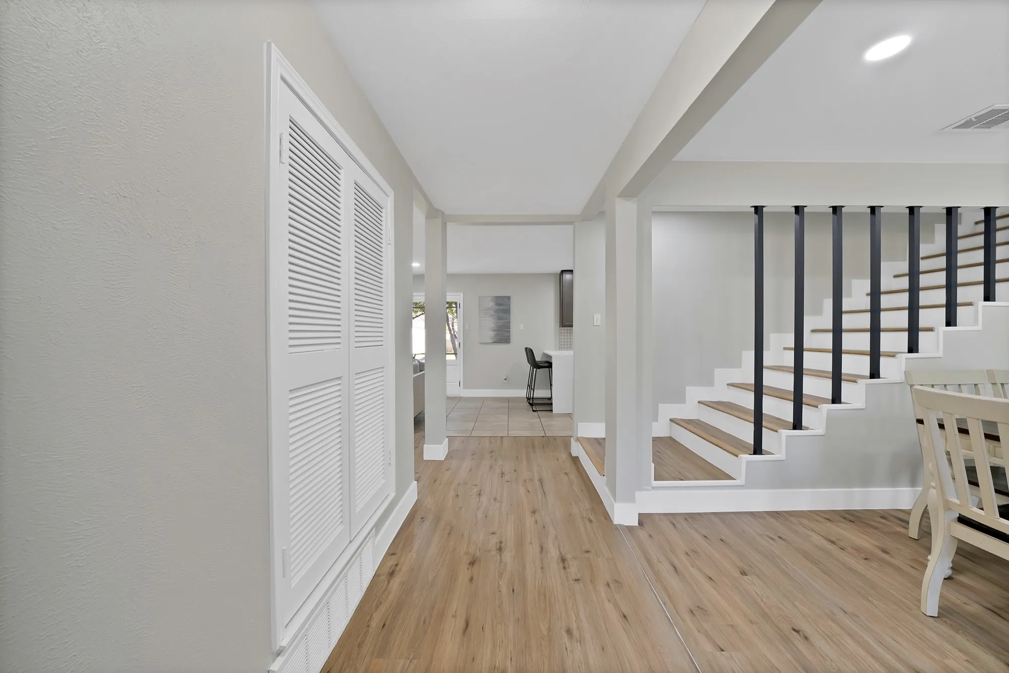 Entrance foyer with stairs and light wood-style flooring