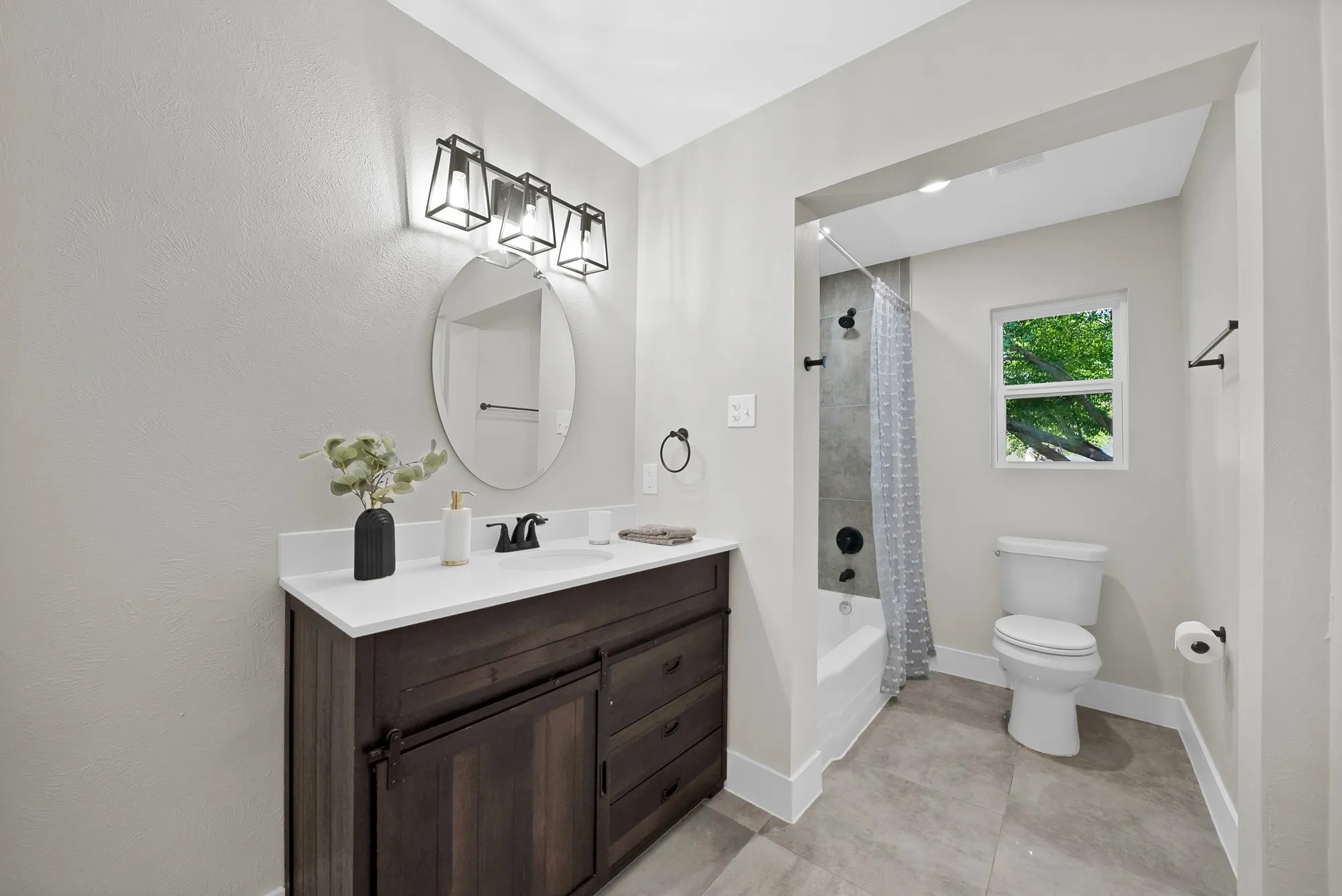 Bathroom with vanity and shower / tub combo