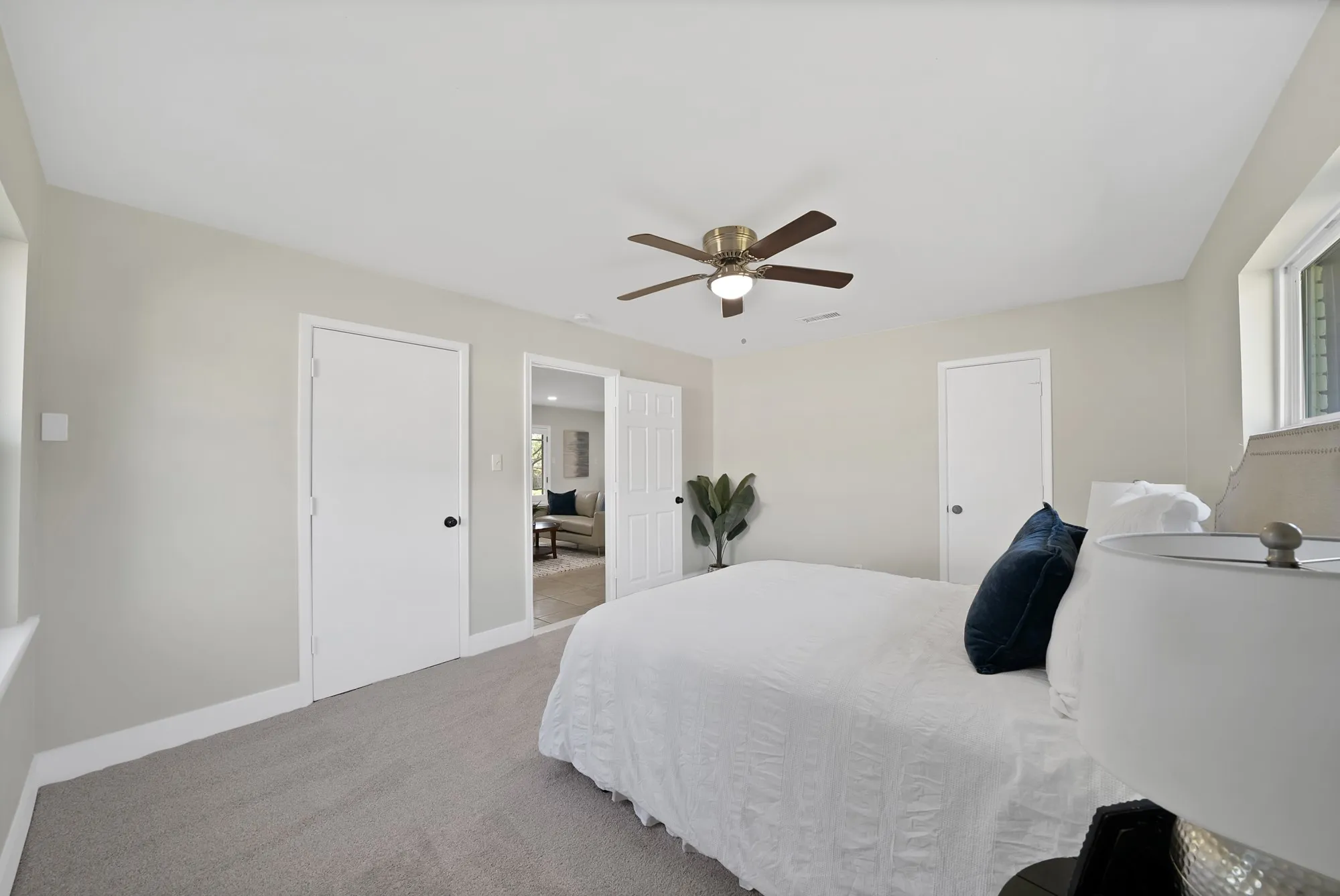 Bedroom featuring light colored carpet and a ceiling fan