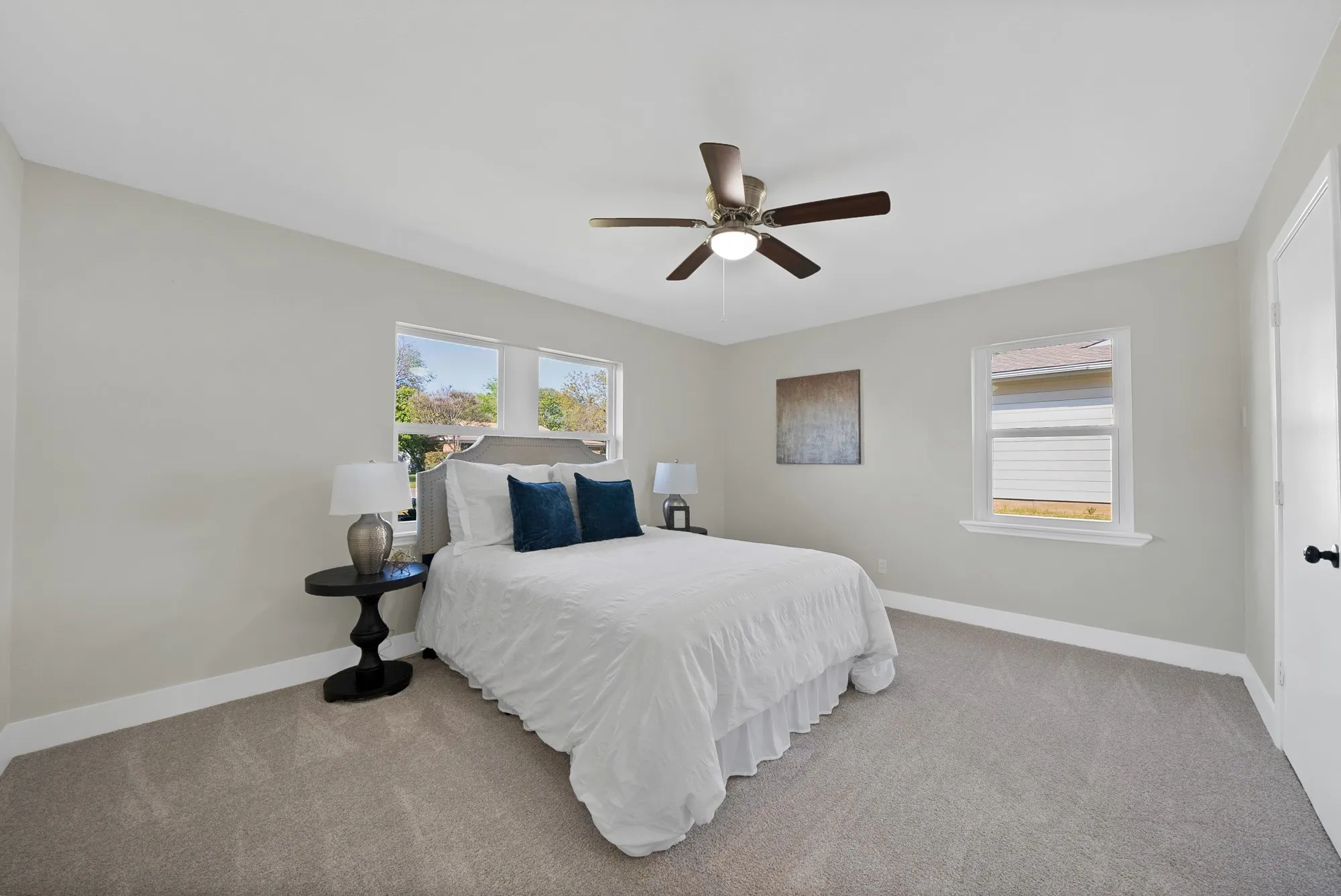 Bedroom featuring light carpet and ceiling fan