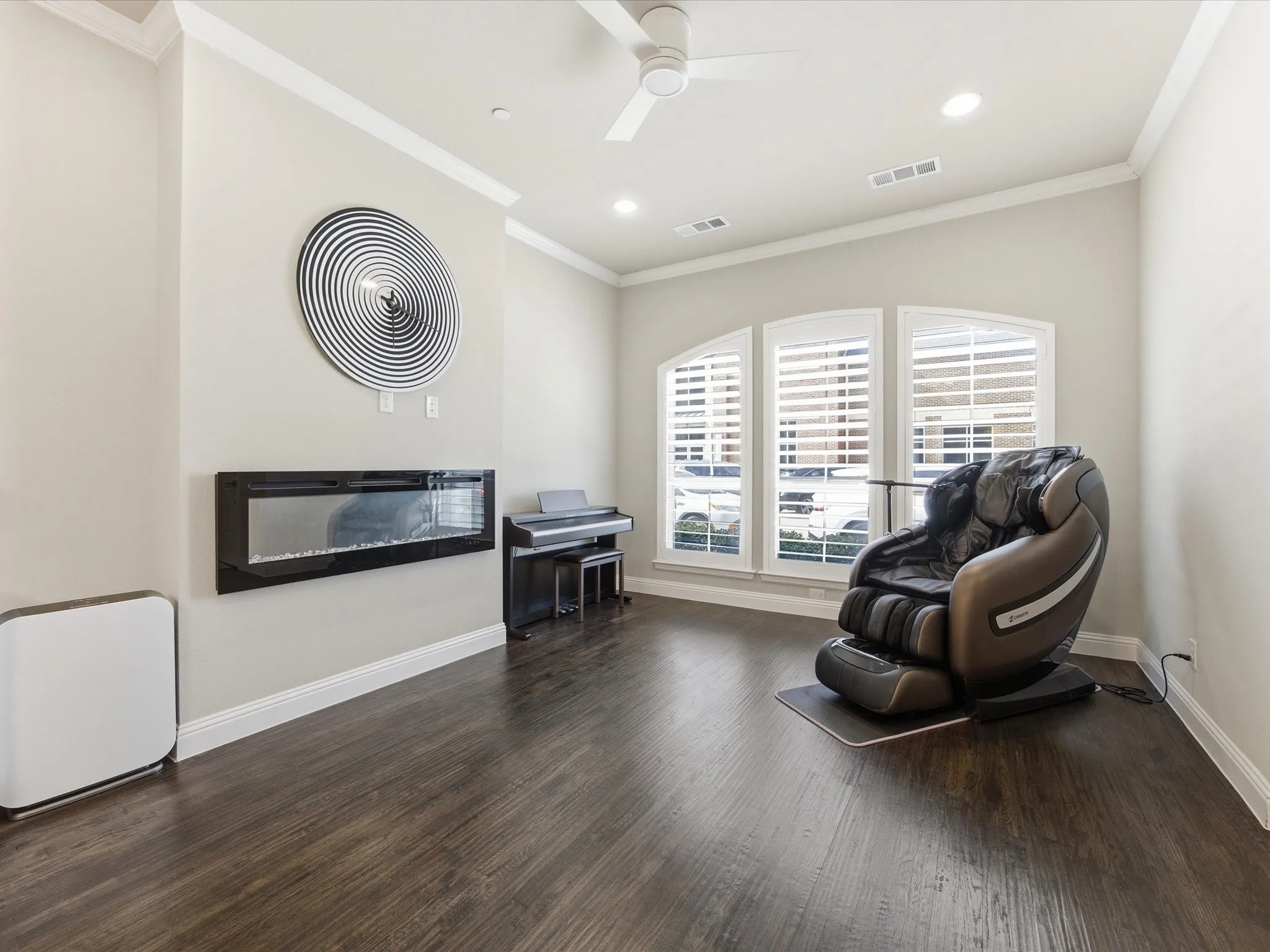 Living area with a glass covered fireplace, dark wood-style floors, crown molding, a ceiling fan, and recessed lighting
