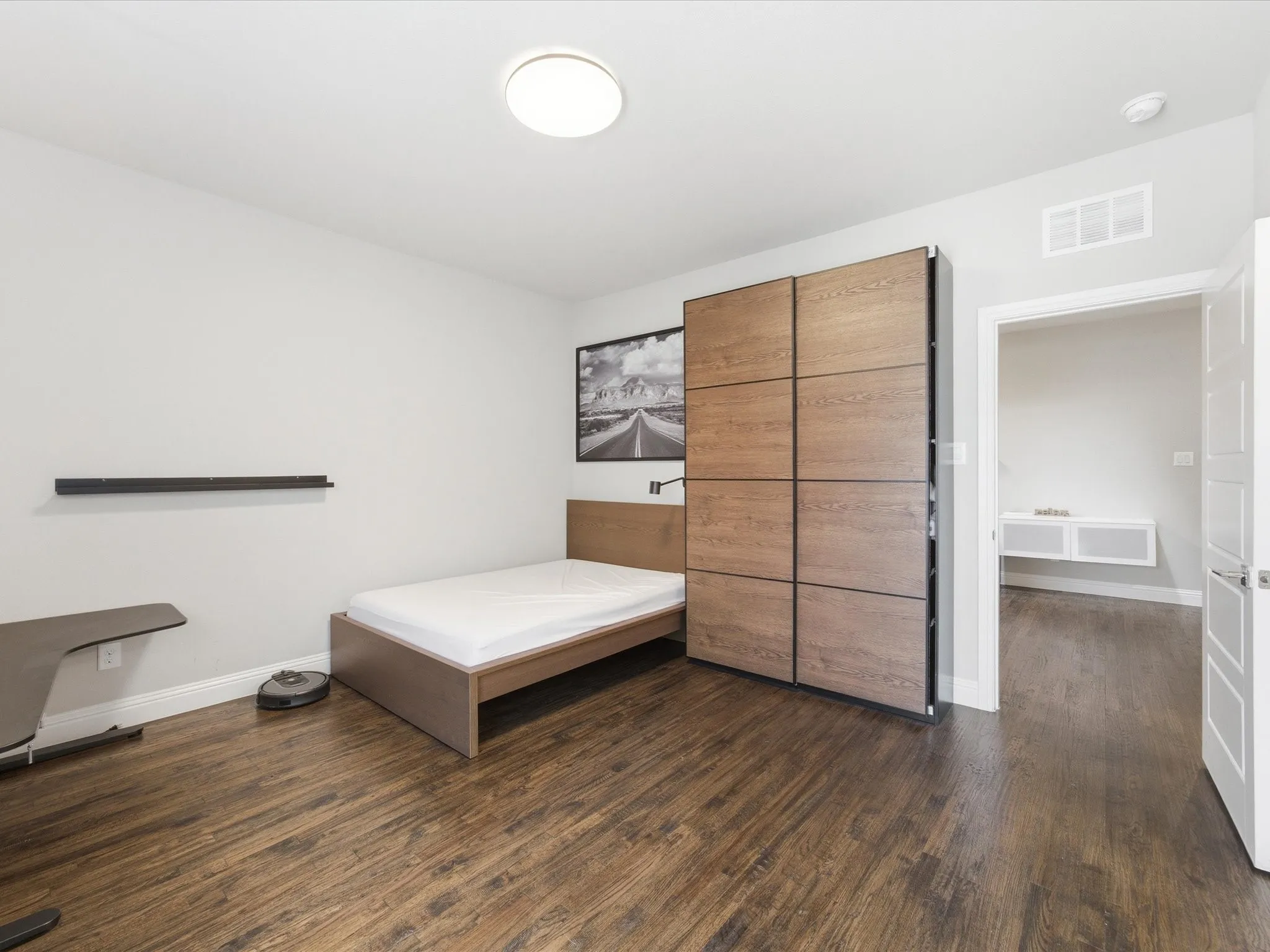 Bedroom featuring dark wood finished floors and baseboards
