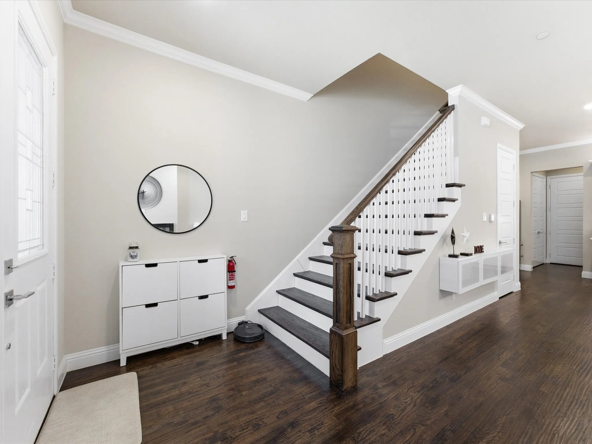 Stairs featuring crown molding and wood finished floors