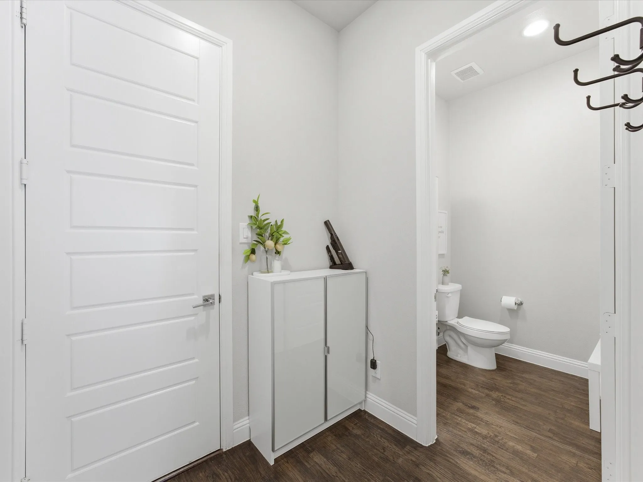 Bathroom featuring baseboards and dark wood finished floors
