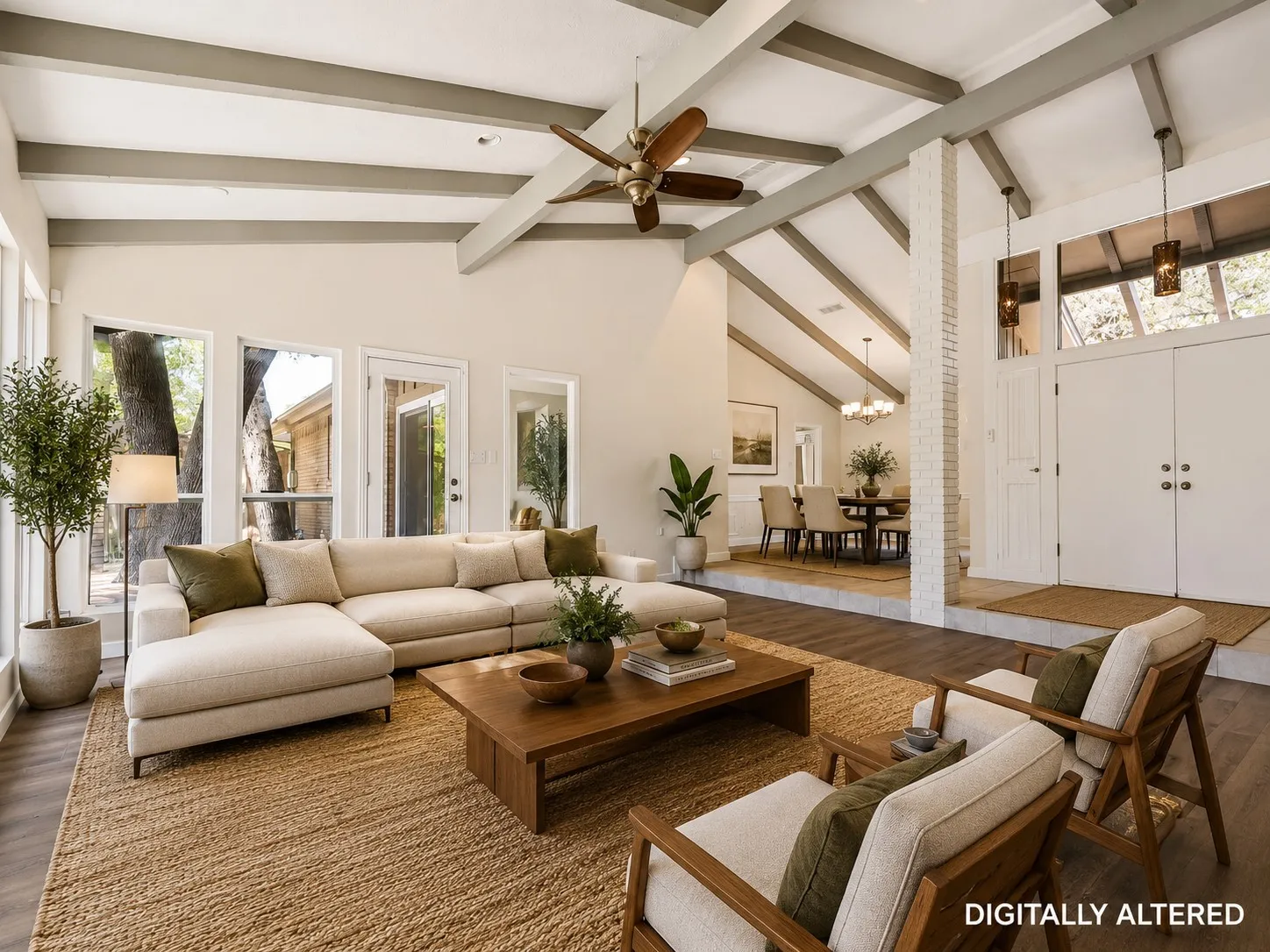 Spacious living area featuring a vaulted ceiling with exposed beams, wood-finish flooring, and multiple large windows - Virtual Staging
