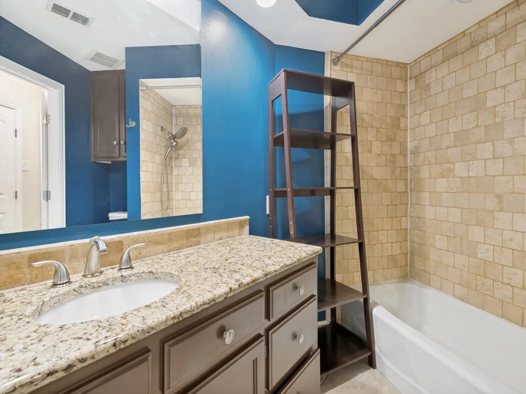 Bathroom featuring shower / tub combination and vanity