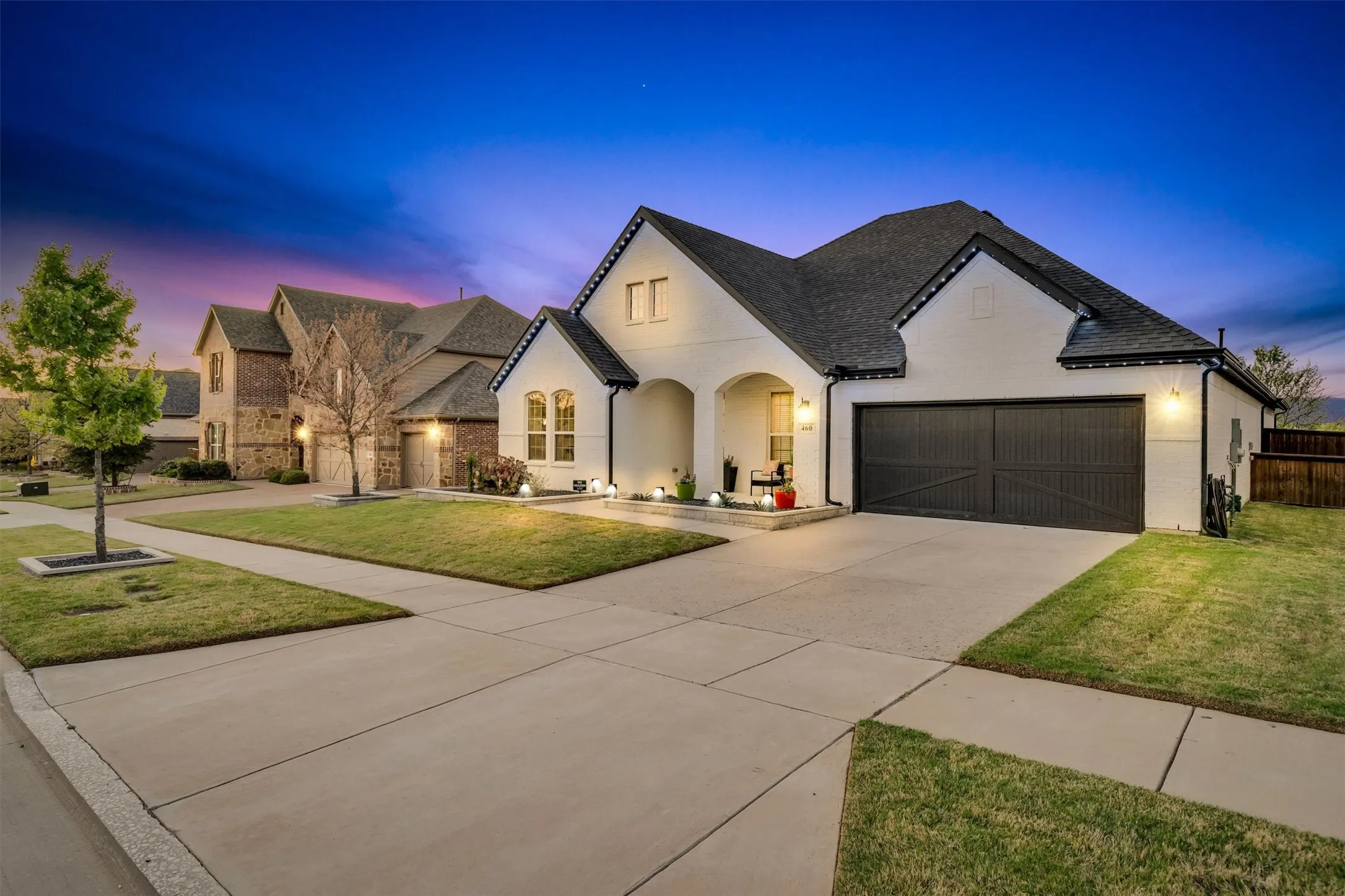front entry with covered porch and three car garage