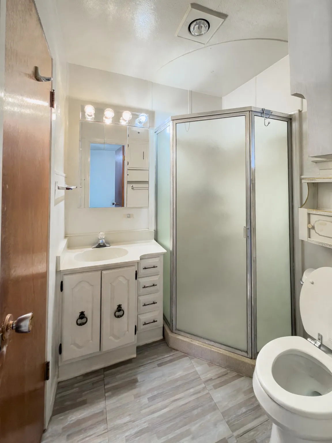Bathroom featuring vanity and a shower stall