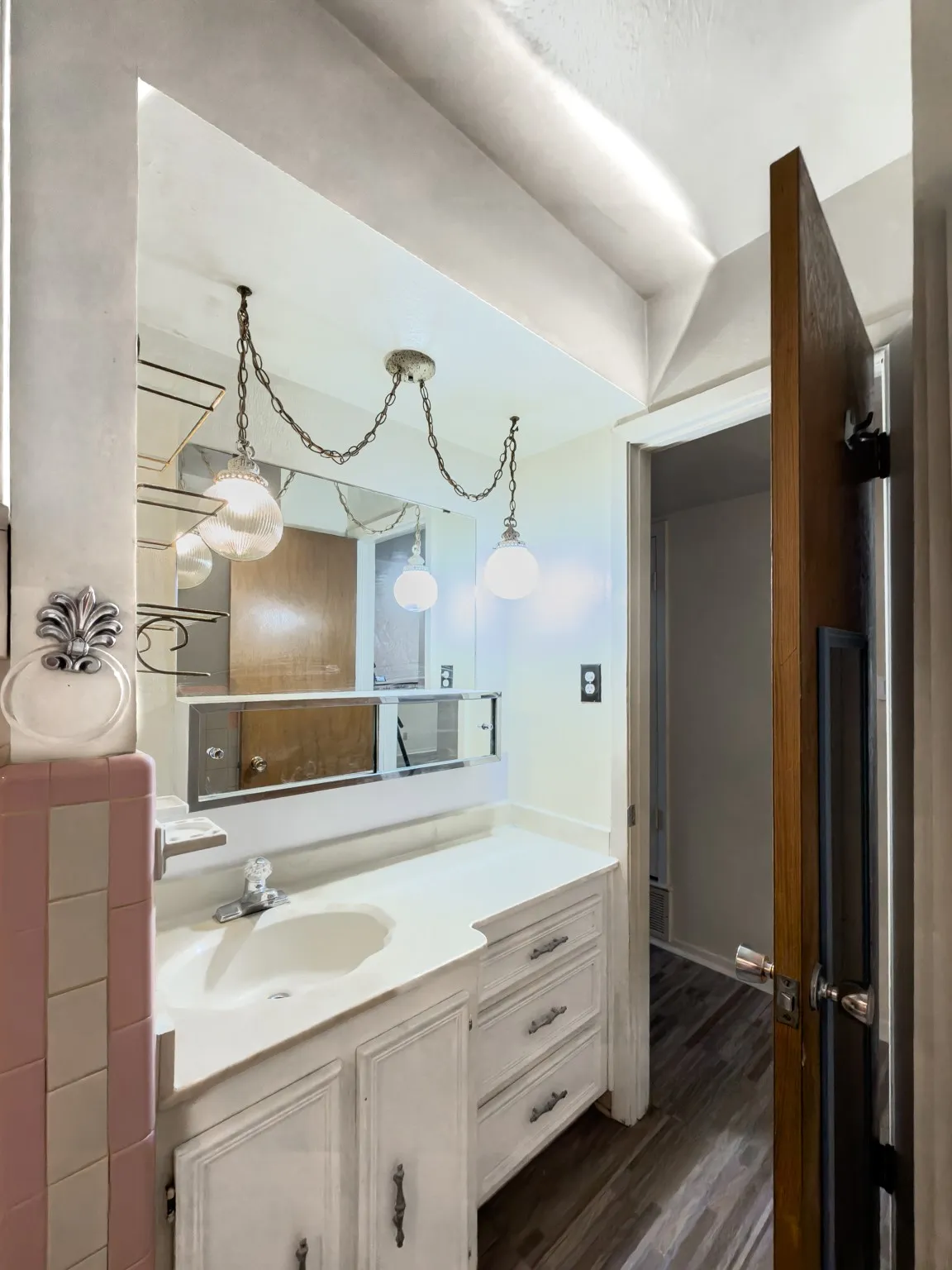 Bathroom featuring vanity and dark wood finished floors