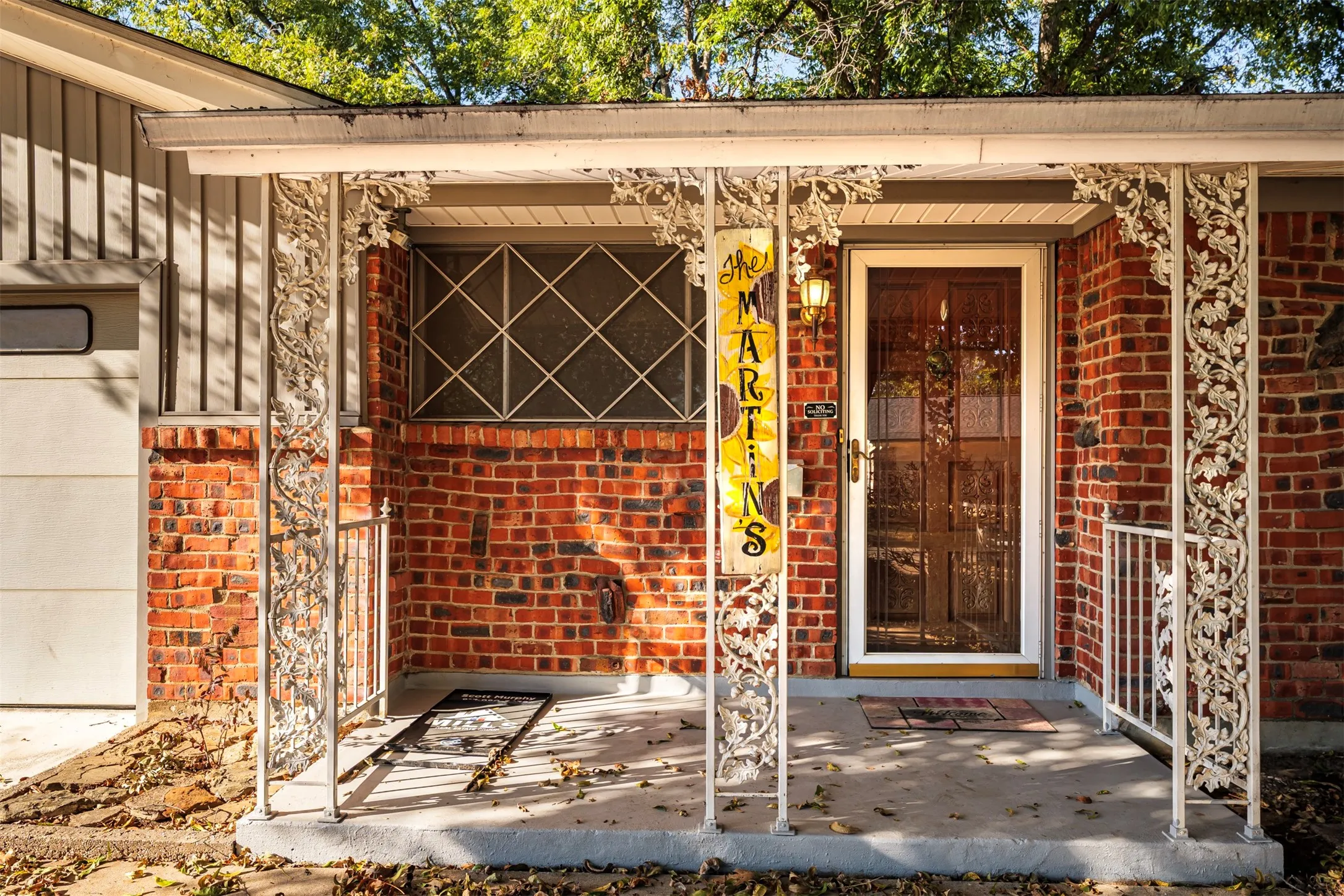 Property entrance with brick siding and board and batten siding